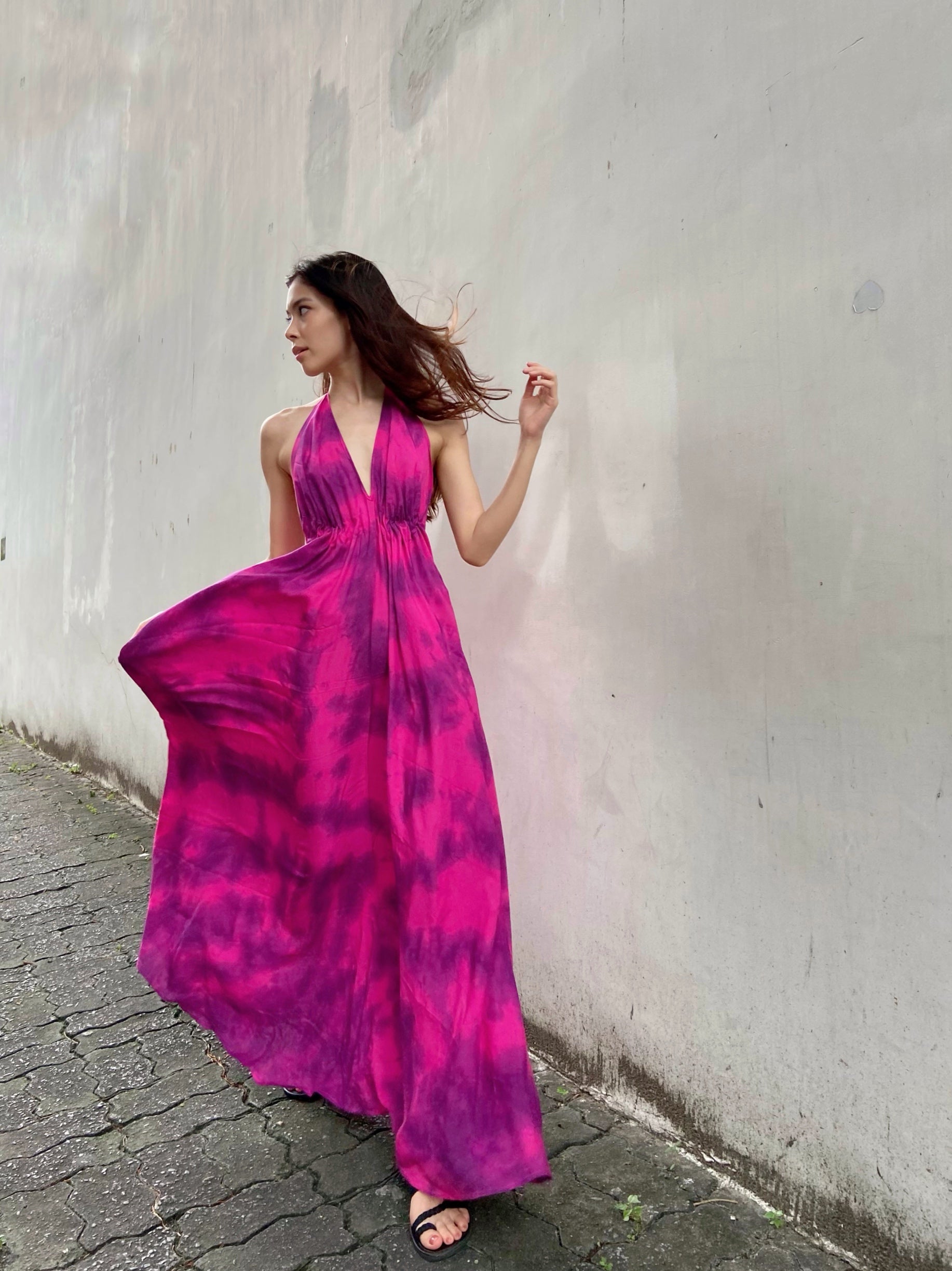Hot pink halter maxi dress with a flowing silhouette, perfect for summer vacations, beach days, or resort wear by Coco De Chom