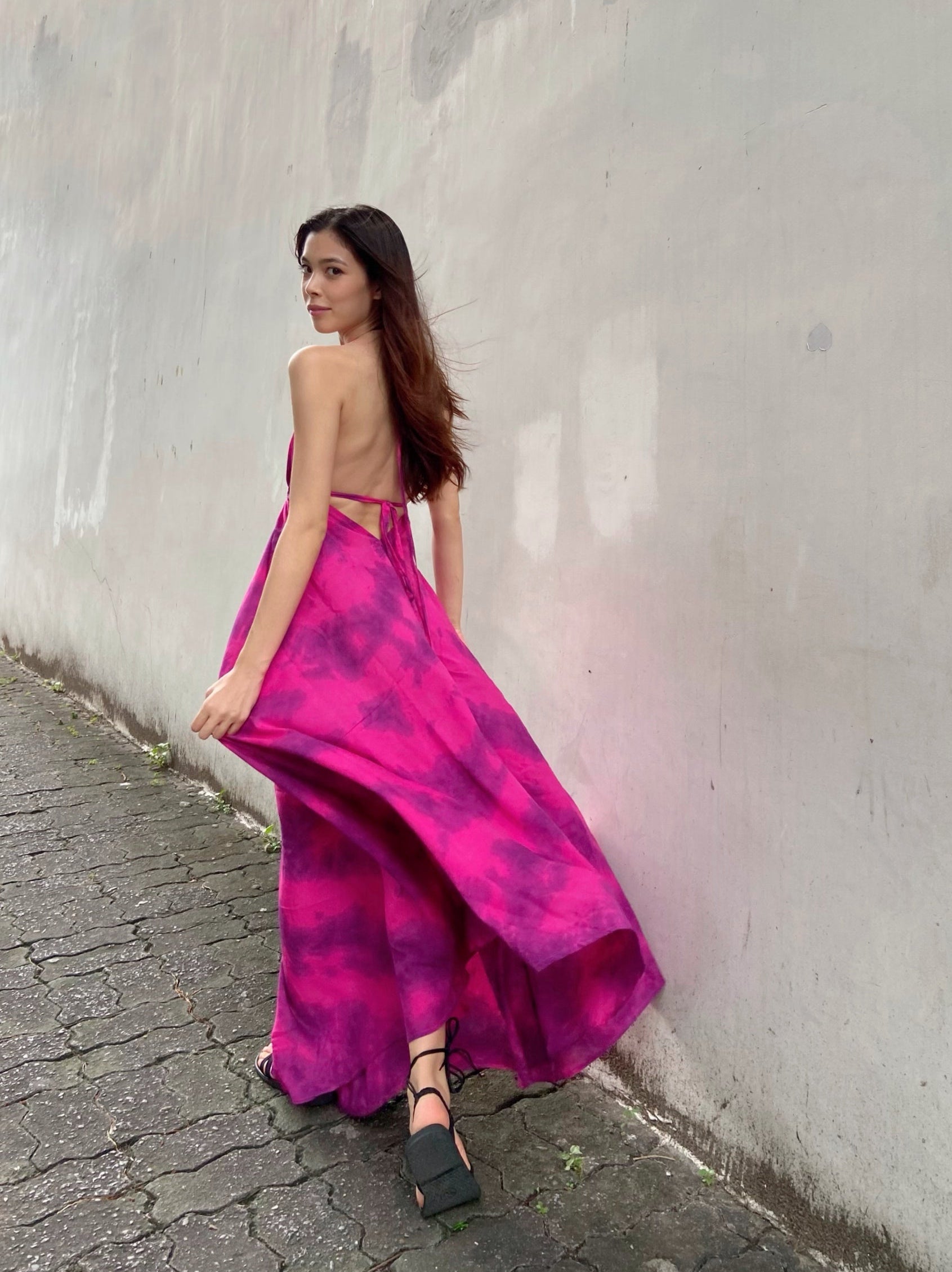 Hot pink halter maxi dress with a flowing silhouette, perfect for summer vacations, beach days, or resort wear by Coco De Chom