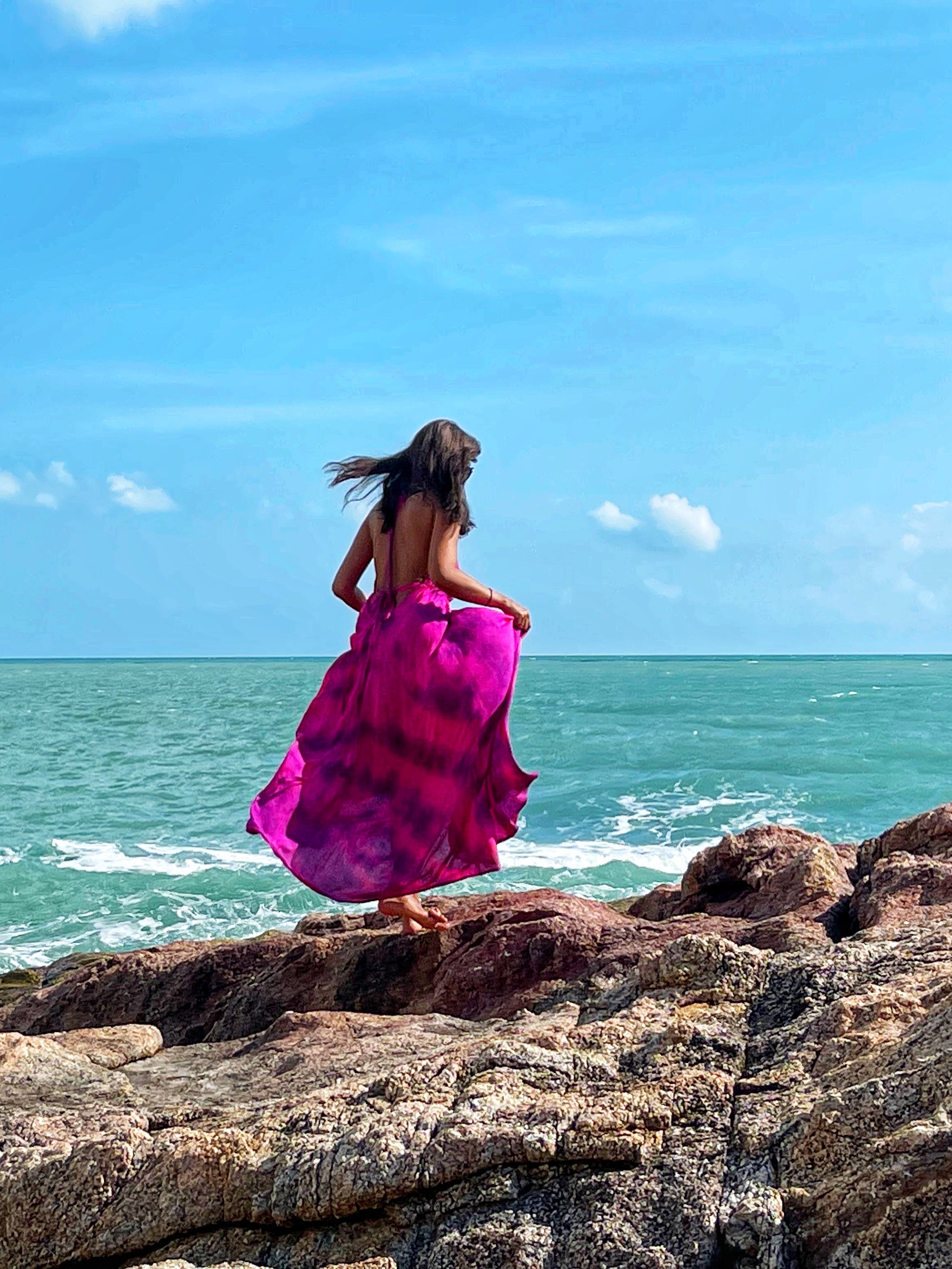 Hot pink halter maxi dress with a flowing silhouette, perfect for summer vacations, beach days, or resort wear by Coco De Chom