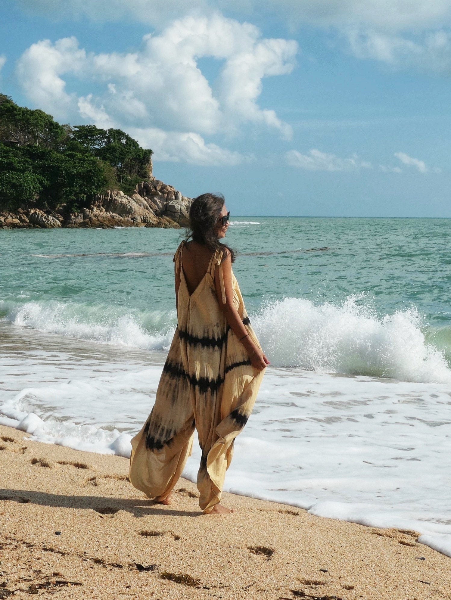 Woman wearing the ‘Thara’ yoga jumpsuit with an oversized fit and back-V silhouette, perfect for yoga, beach cover-up, or casual day-to-night wear by Coco De Chom.