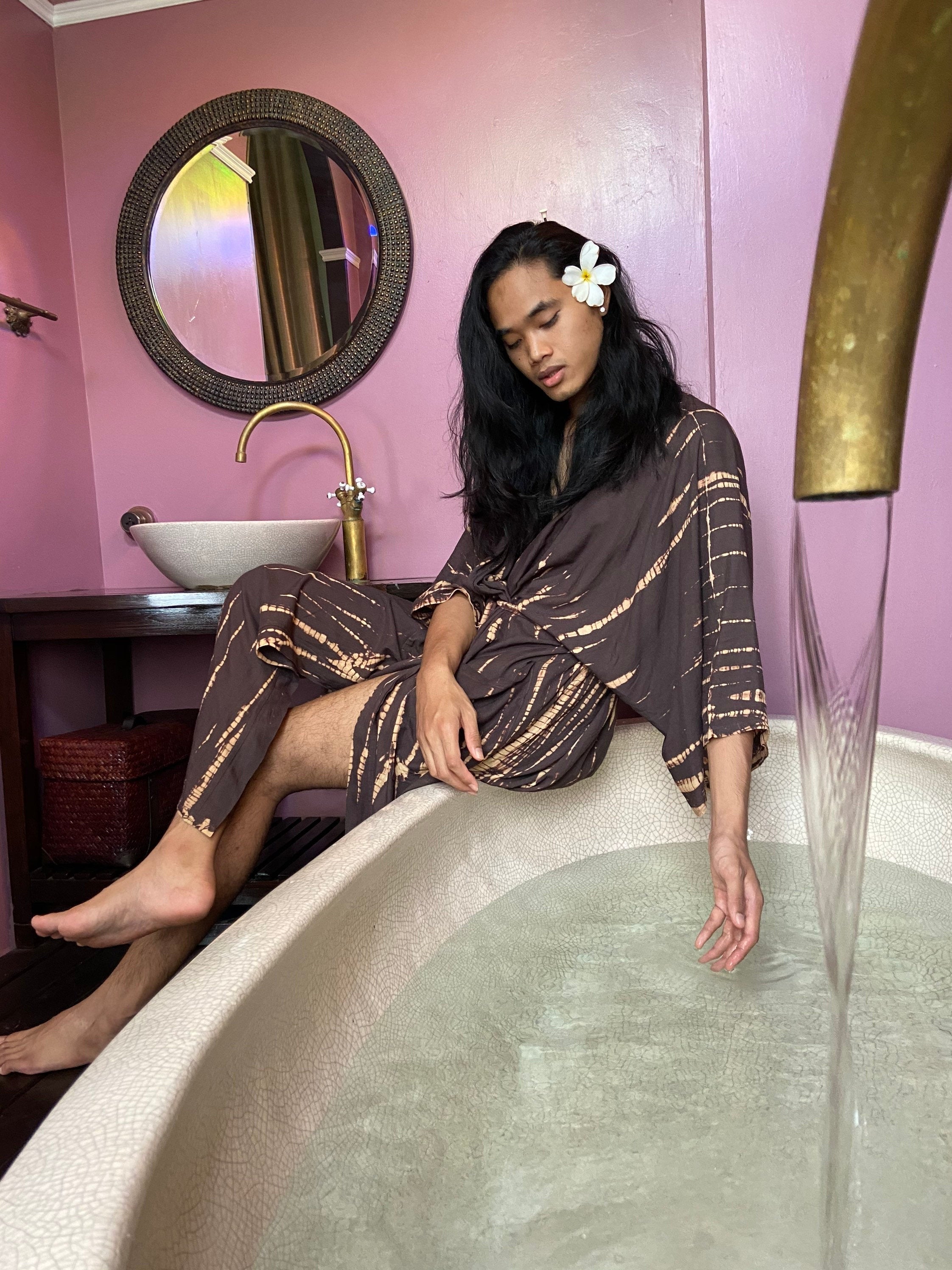 man lounging in oversized boho tie dye kimono robe in brown, relaxed vacation look