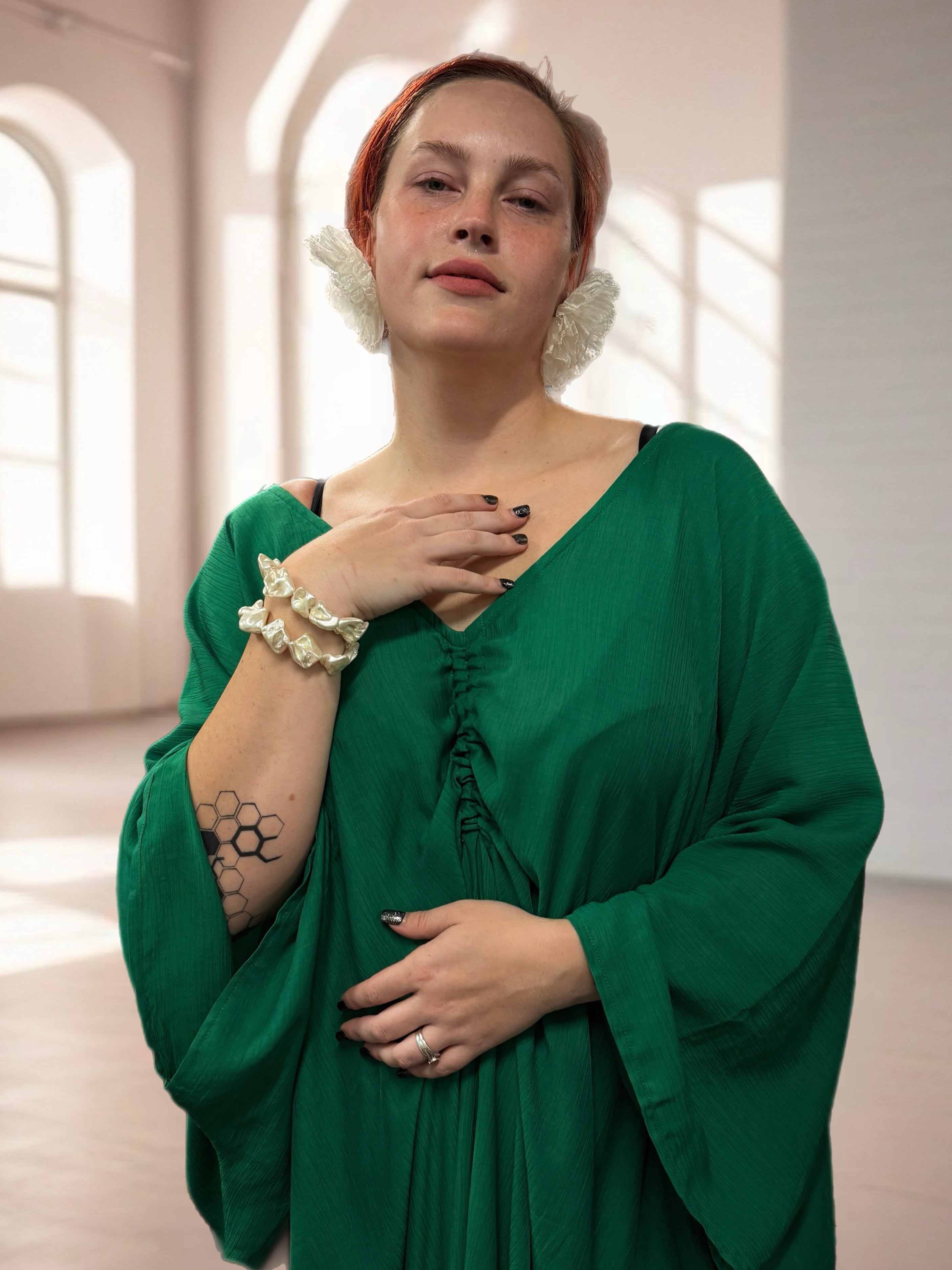 Woman in an Oversized emerald green long sleeve caftan maxi dress, plus size boho resort dress and cruise vacation outfit with airy flowy maxi movement