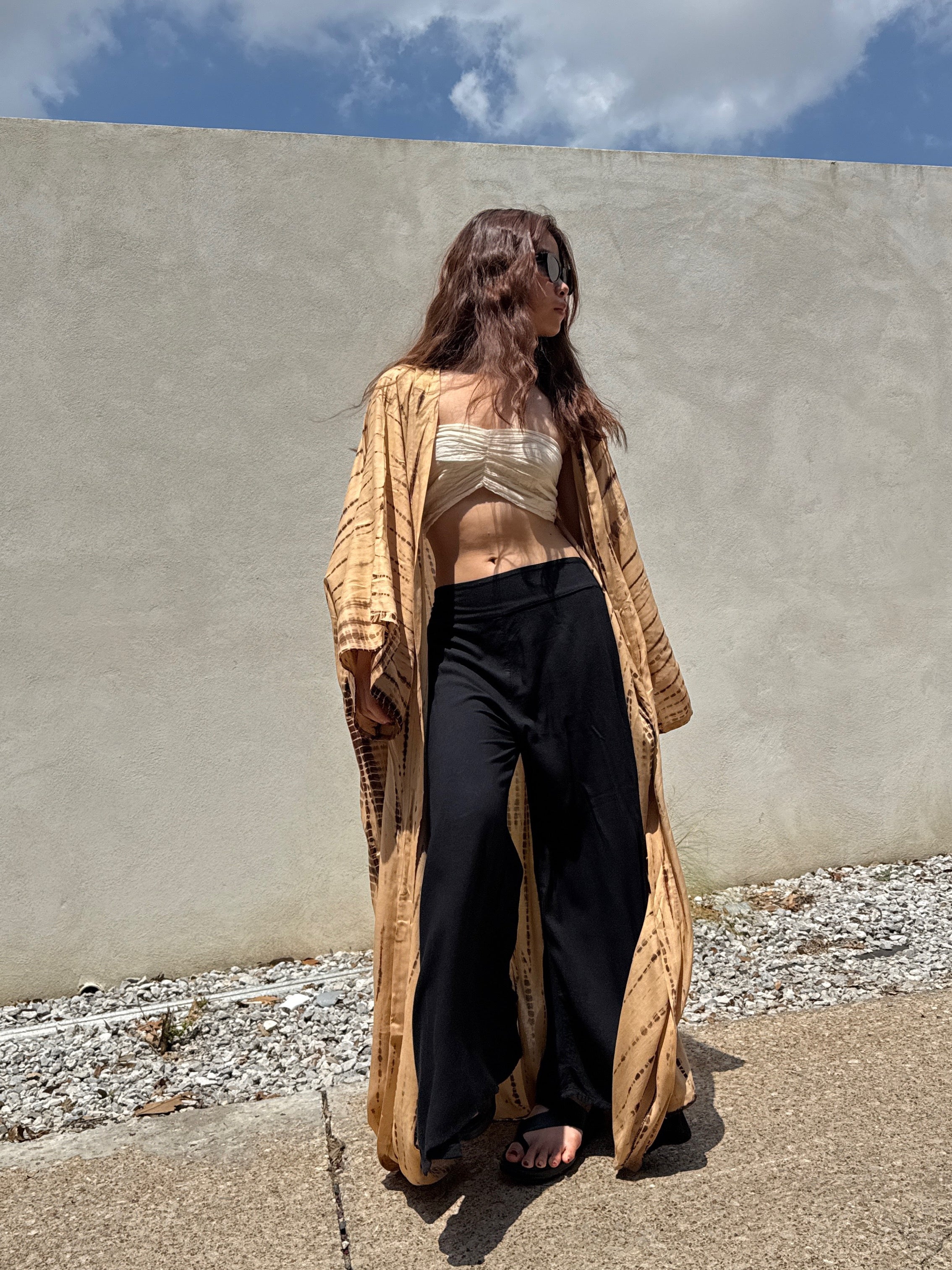 Woman wearing a tan tie-dye long kimono robe from Coco de Chom. The oversized robe features long sleeves, a waist tie, and a relaxed, boho-style fit.