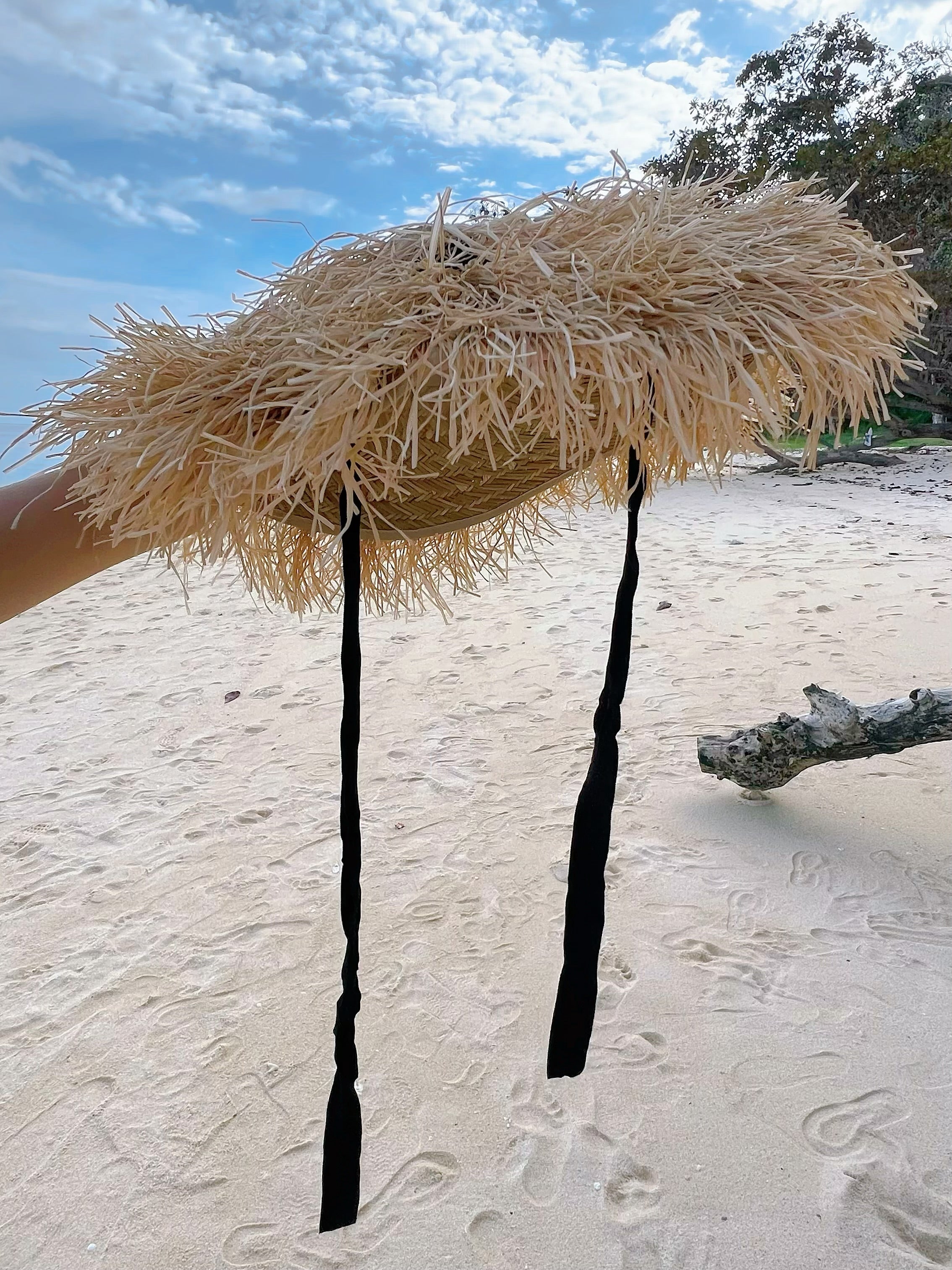 Natural Raffia Straw Hat – your ultimate beach accessory! Handmade with sustainable materials, this sun hat combines chic style with practicality. Featuring charming ribbon ties, it offers the perfect blend of fashion and sun protection. 