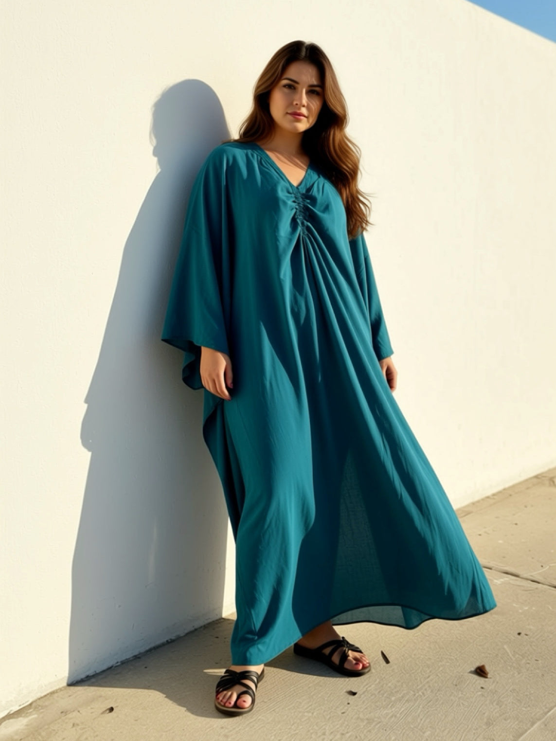 Woman plus size wearing teal kaftan maxi, plus size swim cover up and resort dress, relaxed oversized fit with airy movement