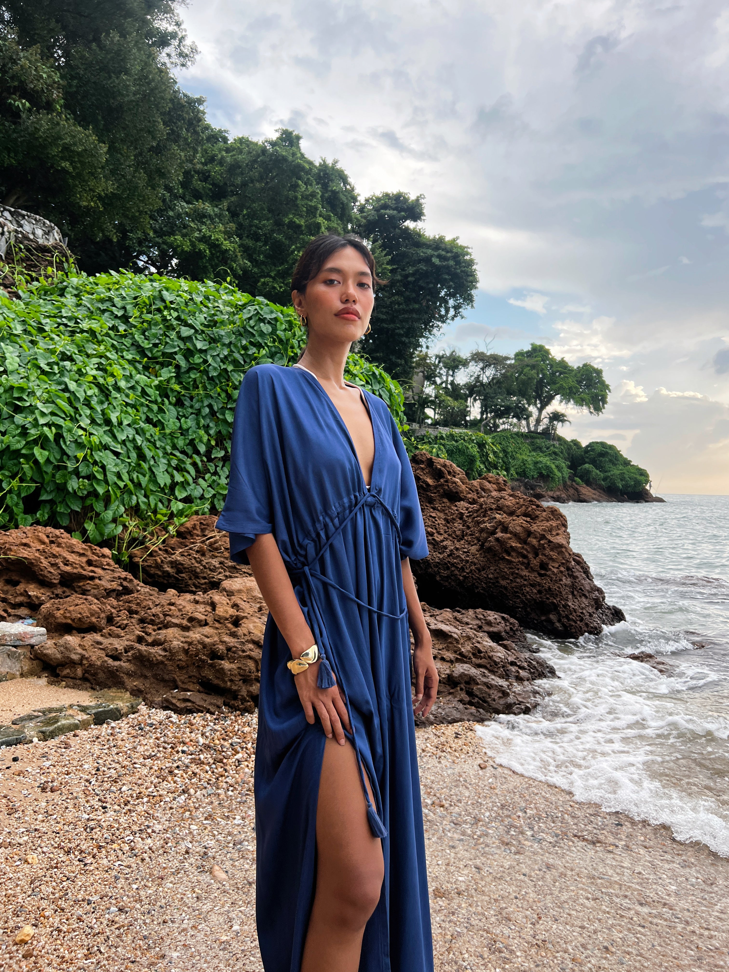 Shop comfort and elegance with our Goddess Kaftan Maxi Dress. This navy hand-dyed kaftan features a flowy, silky feel and a V-neck, making it the ideal choice for resort wear or vacation wear.