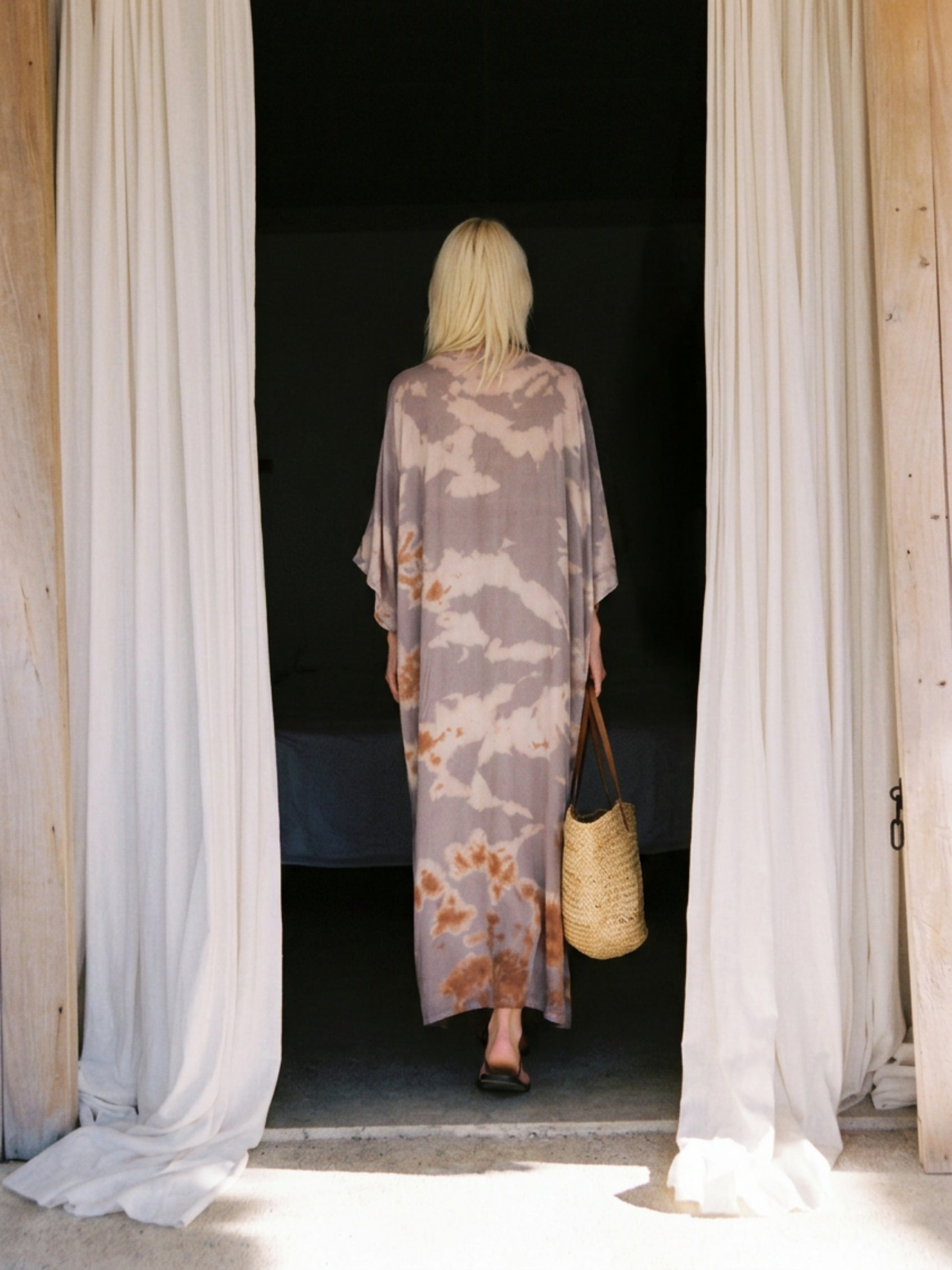 Woman wearing seafoam sand tie dye kaftan maxi dress, flowy resort wear beach cover up, lightweight semi-sheer vacation dress