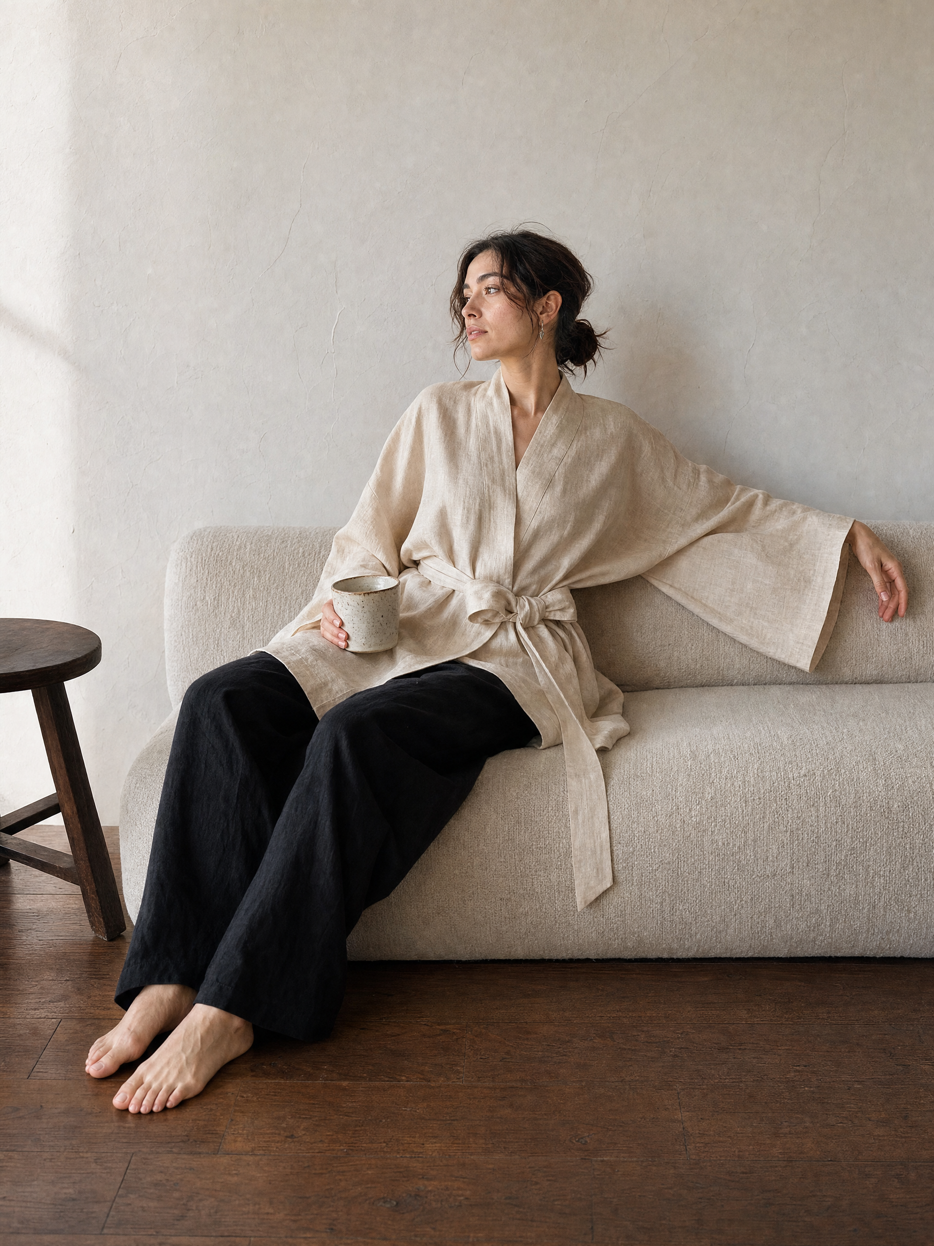 Natural cream linen kimono jacket with oversized wrap fit, wide sleeves, pockets, and removable waist tie, styled as a resort robe and everyday linen layer