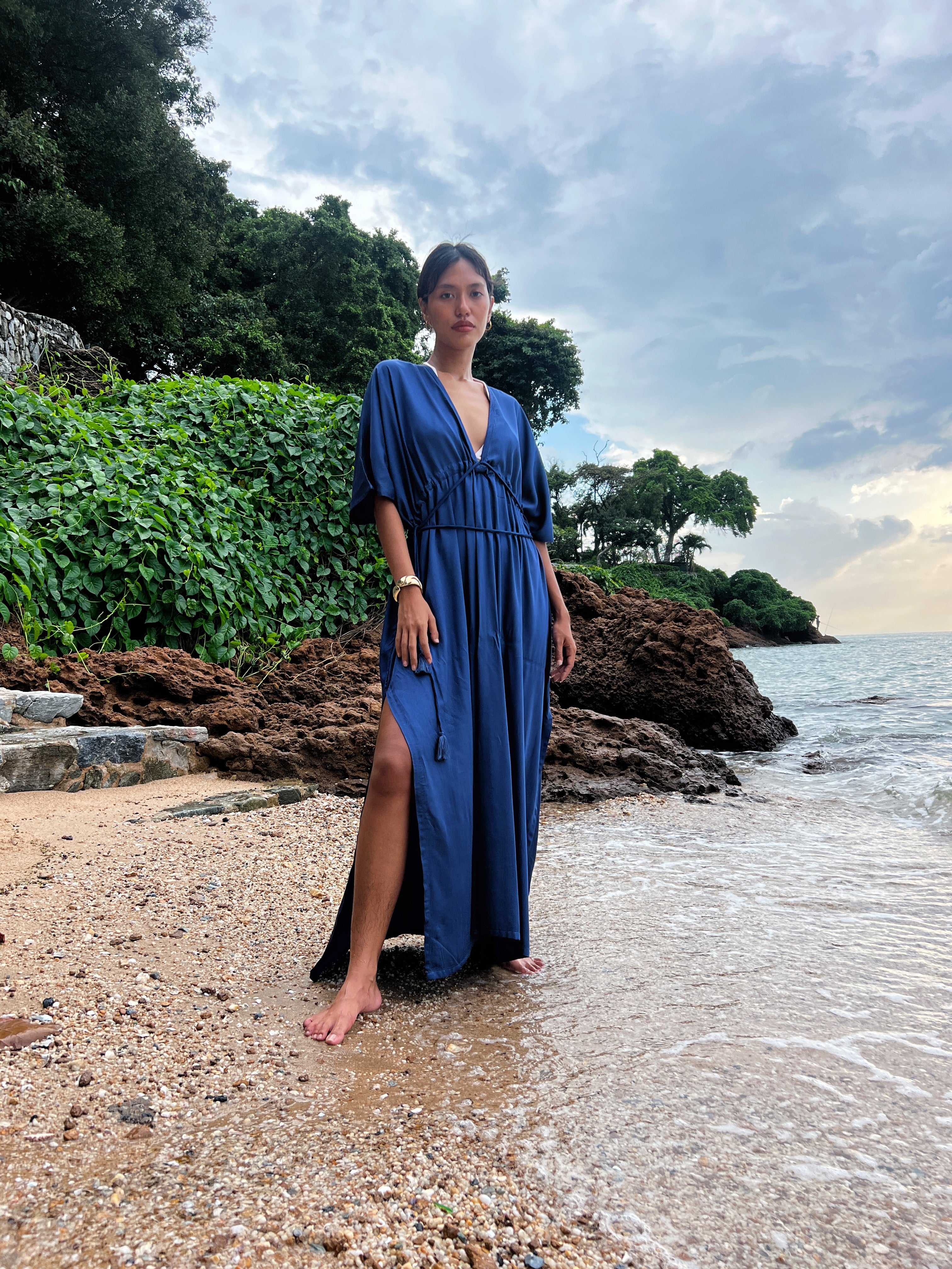 Shop comfort and elegance with our Goddess Kaftan Maxi Dress. This navy hand-dyed kaftan features a flowy, silky feel and a V-neck, making it the ideal choice for resort wear or vacation wear.