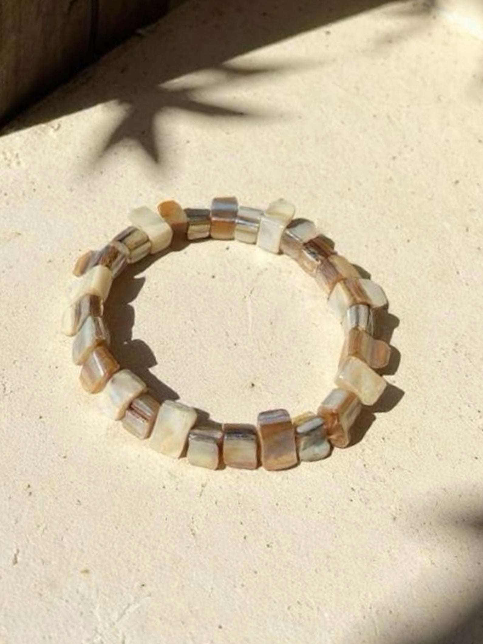 Natural Mother of pearl bracelet on a sandy surface, perfect for beach dress boho style - handmade jewelry