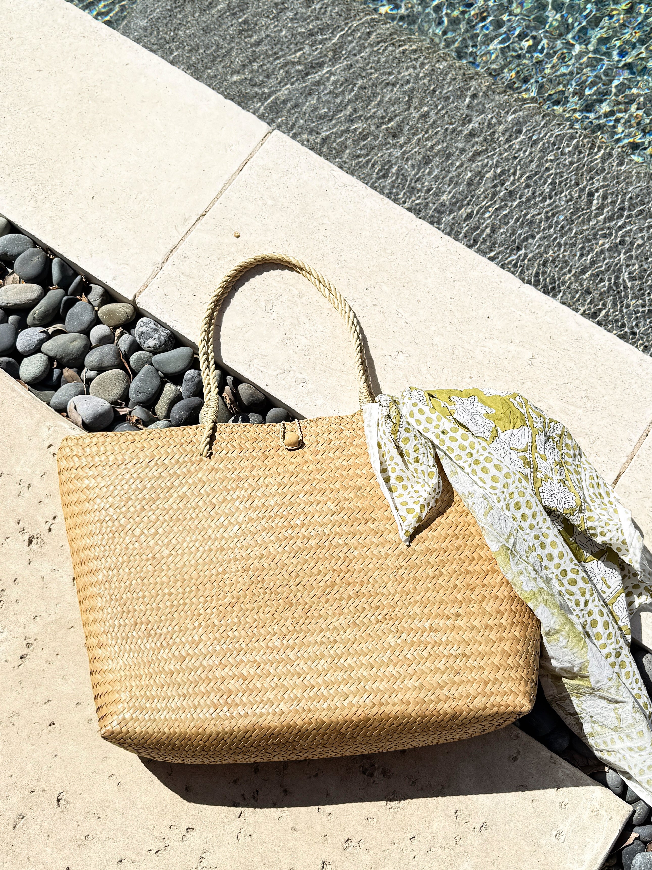 Oversized natural straw beach bag with button loop closure