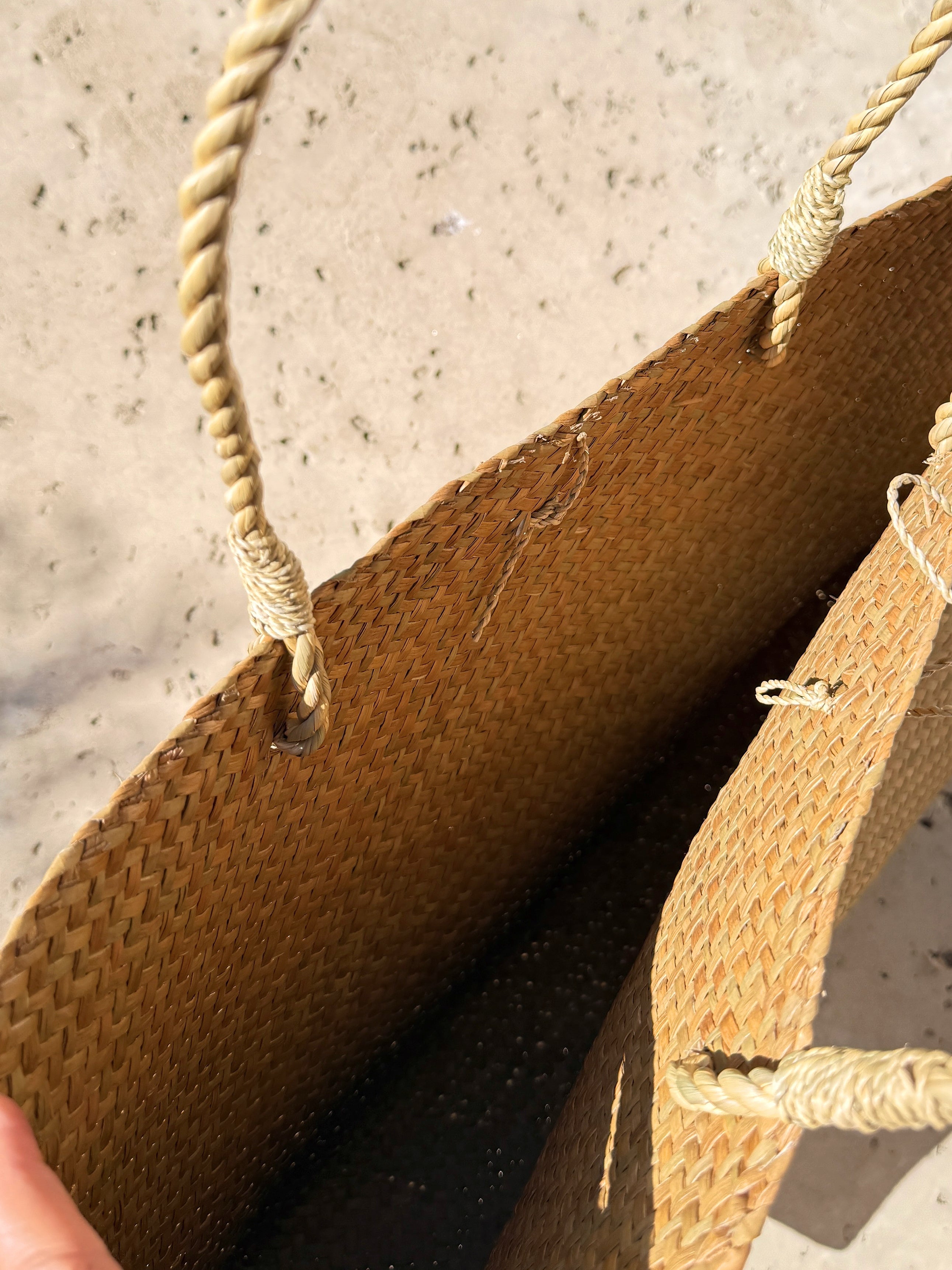 Oversized natural straw beach bag with button loop closure