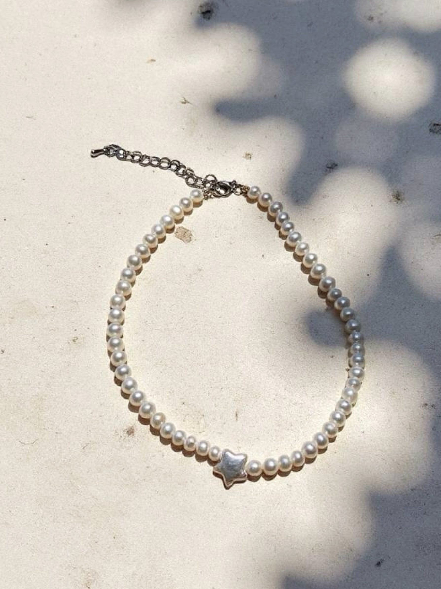North Star Pearl Choker Necklace is the perfect choice for beach vacation or every day wear. This pearl necklace is made using natural water fresh pearl for both the star pendant and necklace for understated elegance. 