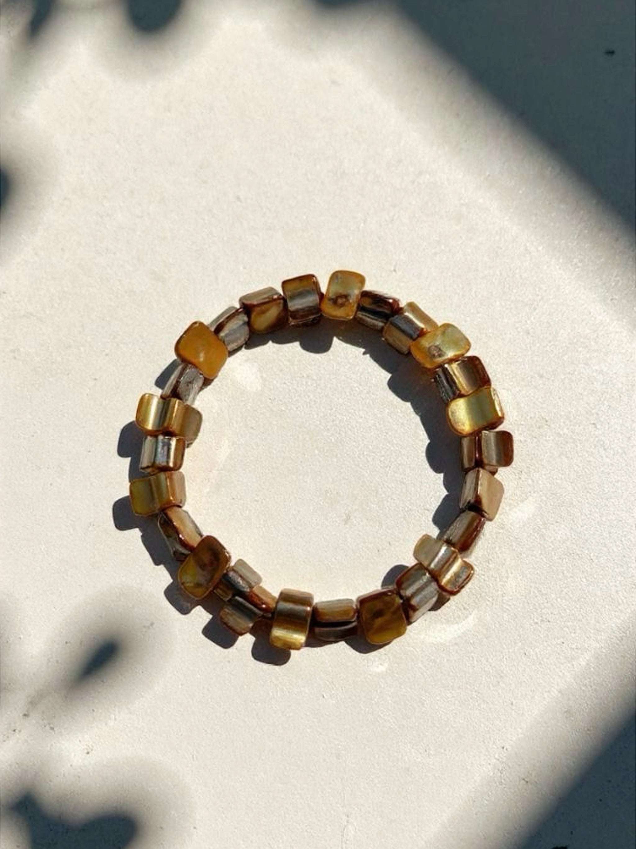 Gold mother of pearl bracelet is the perfect choice for beach vacation or every day wear. This seashell pearl bracelet is made using natural water fresh mother of pearl e for understated elegance. 