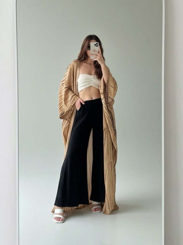 Woman wearing a tan tie-dye long kimono robe from Coco de Chom. The oversized robe features long sleeves, a waist tie, and a relaxed, boho-style fit.