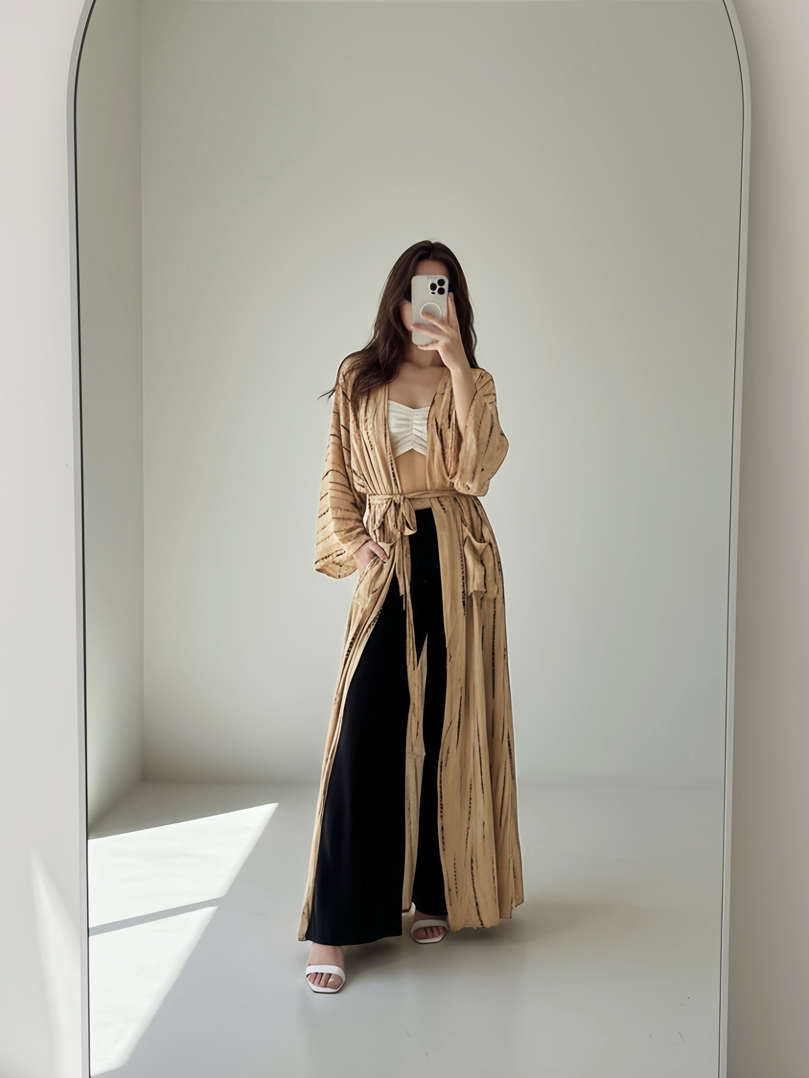 Woman wearing a tan tie-dye long kimono robe from Coco de Chom. The oversized robe features long sleeves, a waist tie, and a relaxed, boho-style fit.