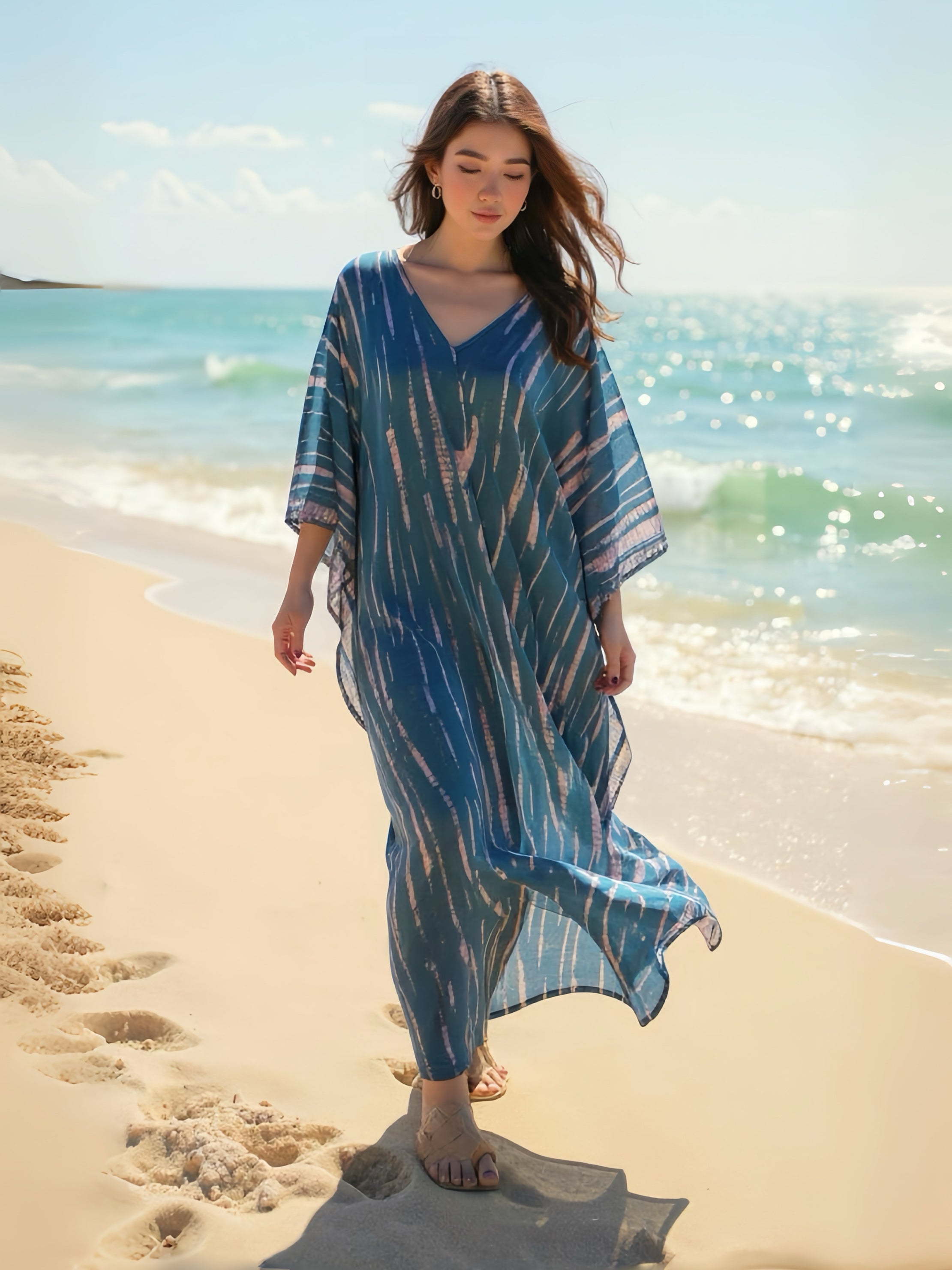 Model wearing a teal tie-dye boho caftan dress; long handmade kaftan perfect as a beach cover-up, vacation kaftan, or oversized resort wear for women. Ideal gift for her and great for lounging or bohemian beachwear style.