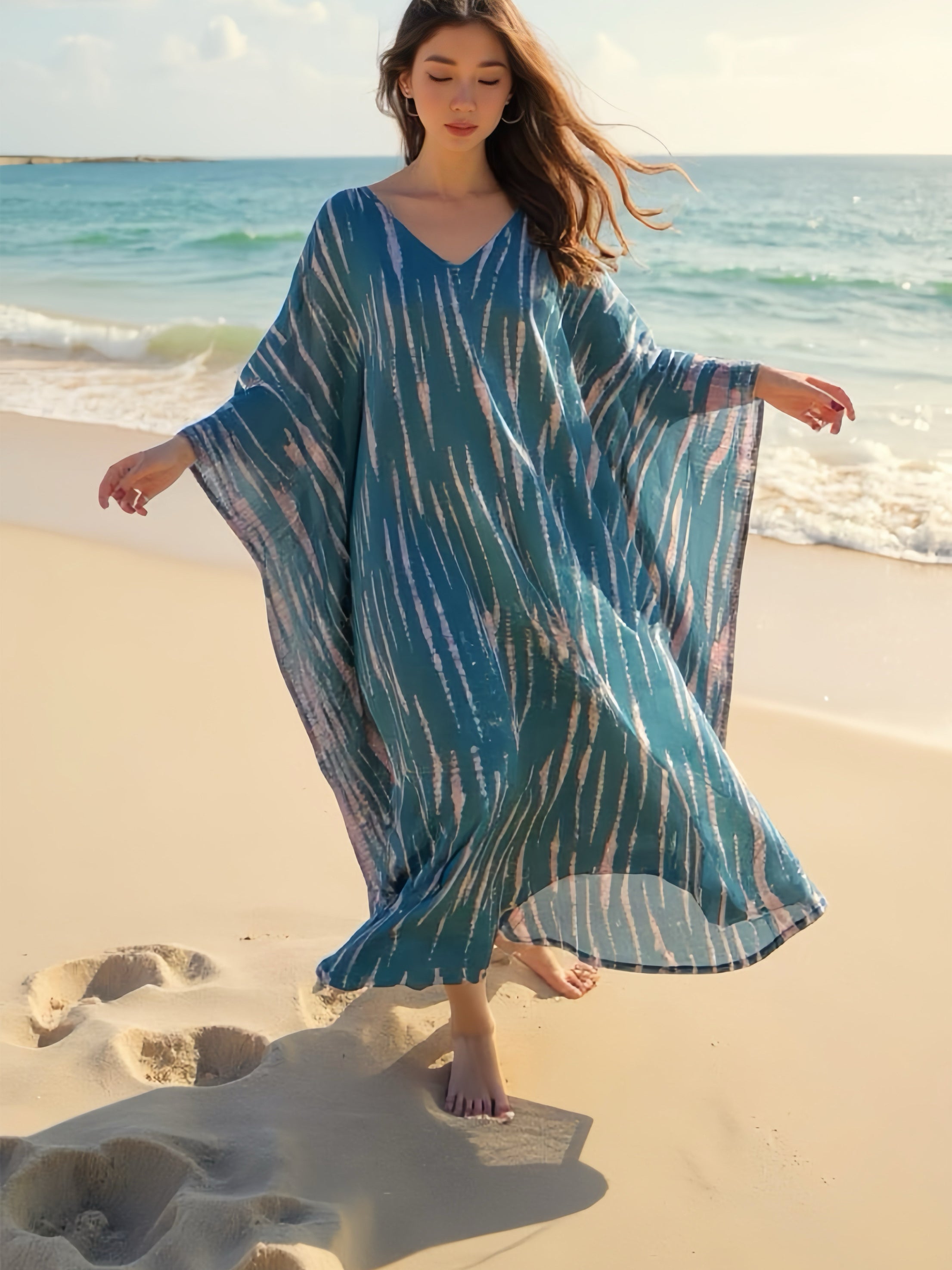 Model wearing a teal tie-dye boho caftan dress; long handmade kaftan perfect as a beach cover-up, vacation kaftan, or oversized resort wear for women. Ideal gift for her and great for lounging or bohemian beachwear style.