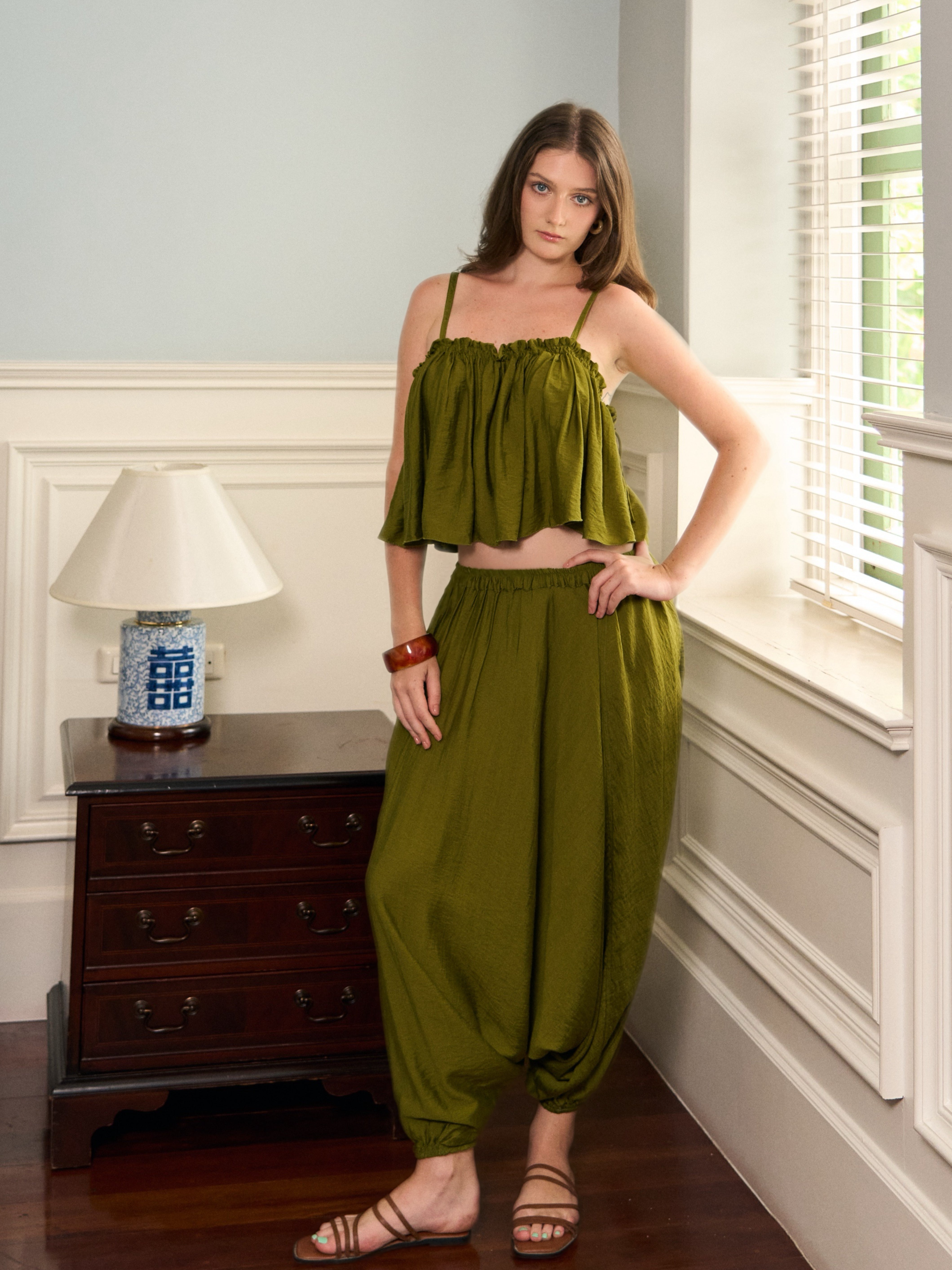 Front view of Mira olive green harem pants with an elastic waist and gathered ankle cuffs
