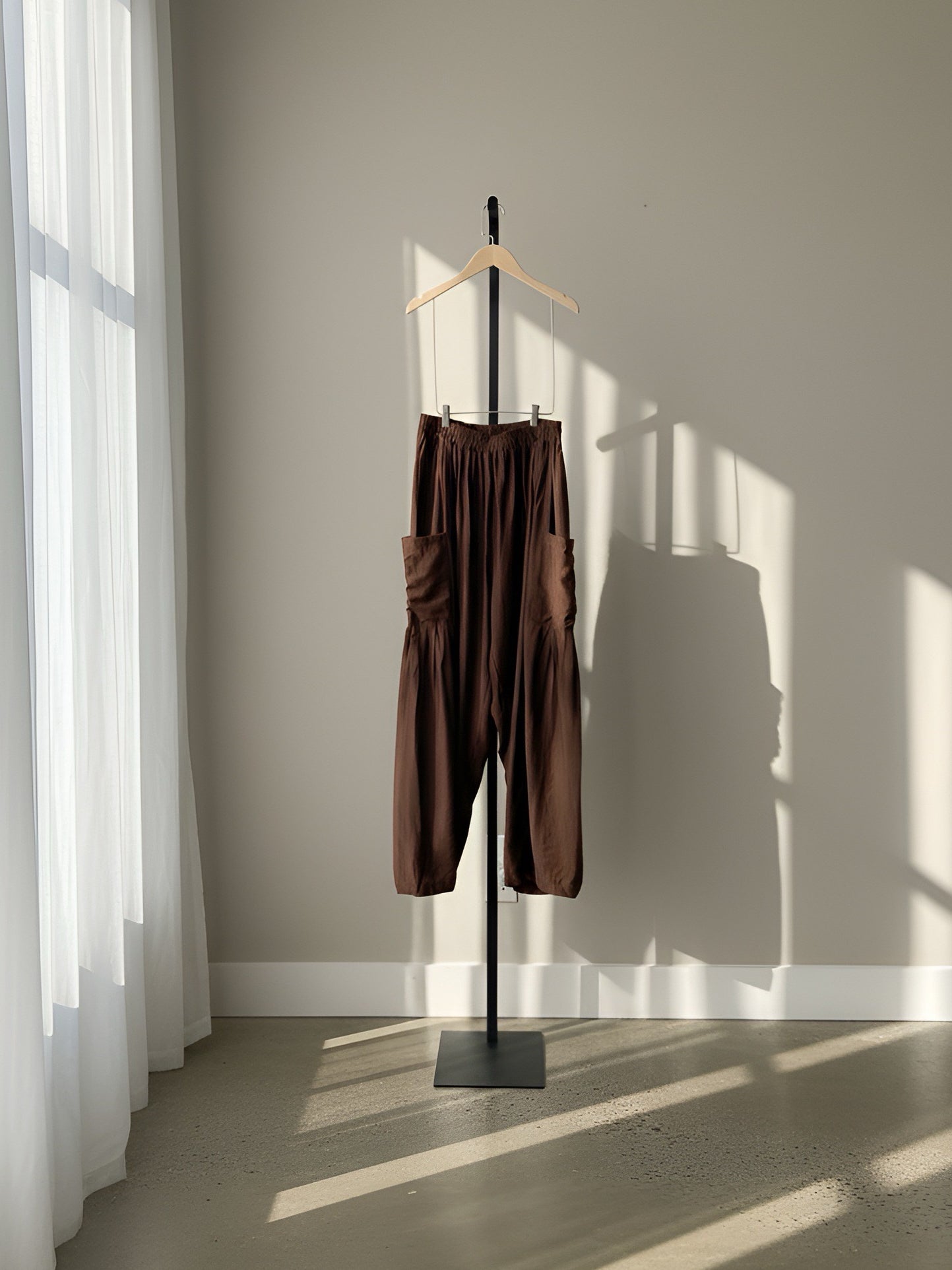 Cocoa brown resort pants hanging on clothing rack