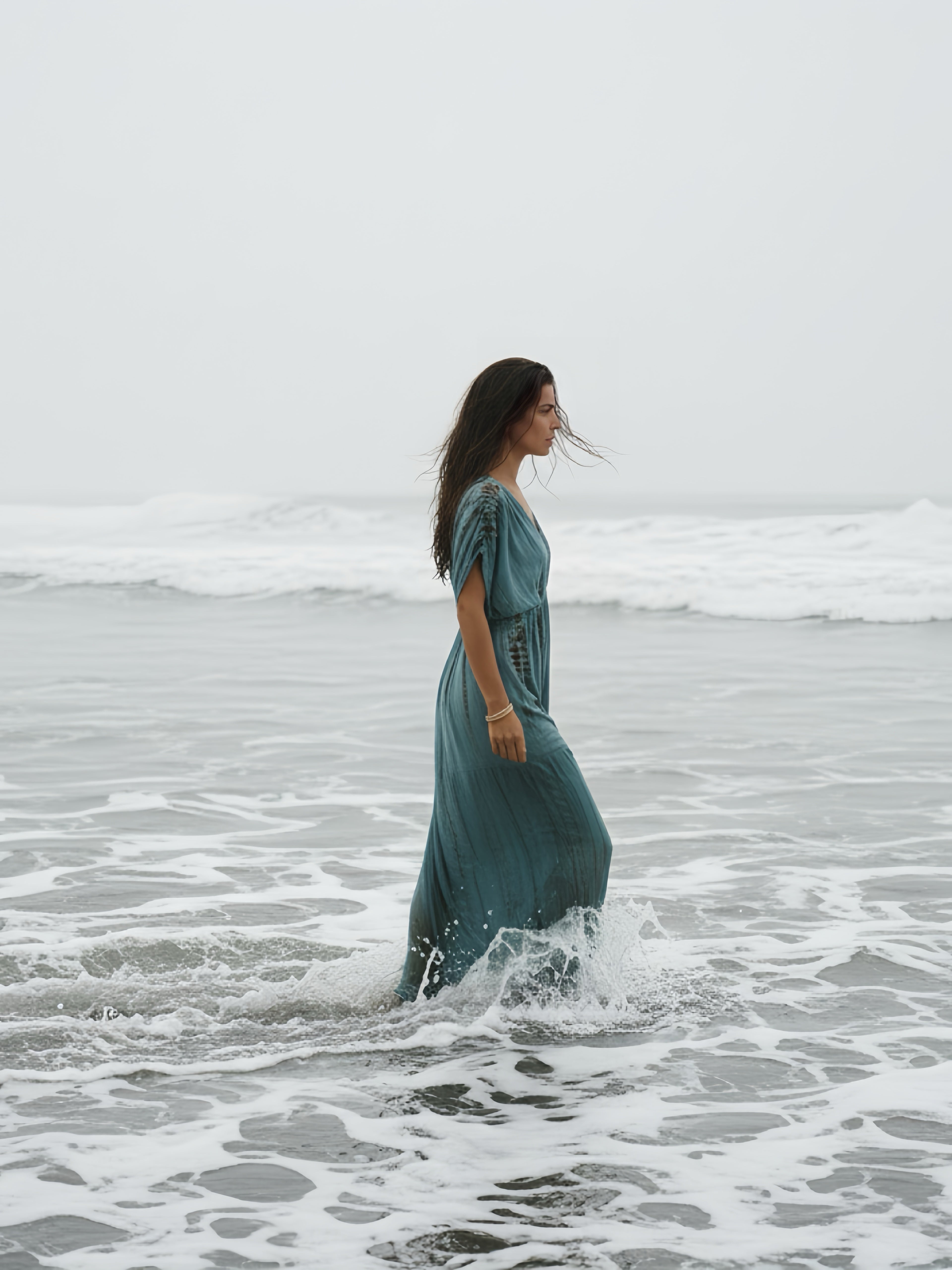Woman wearing the handmade Athena Goddess Kaftan Dress in teal—flowy tie-dye maxi dress with pockets, deep V-neckline, perfect for summer, resort wear, or festivals.