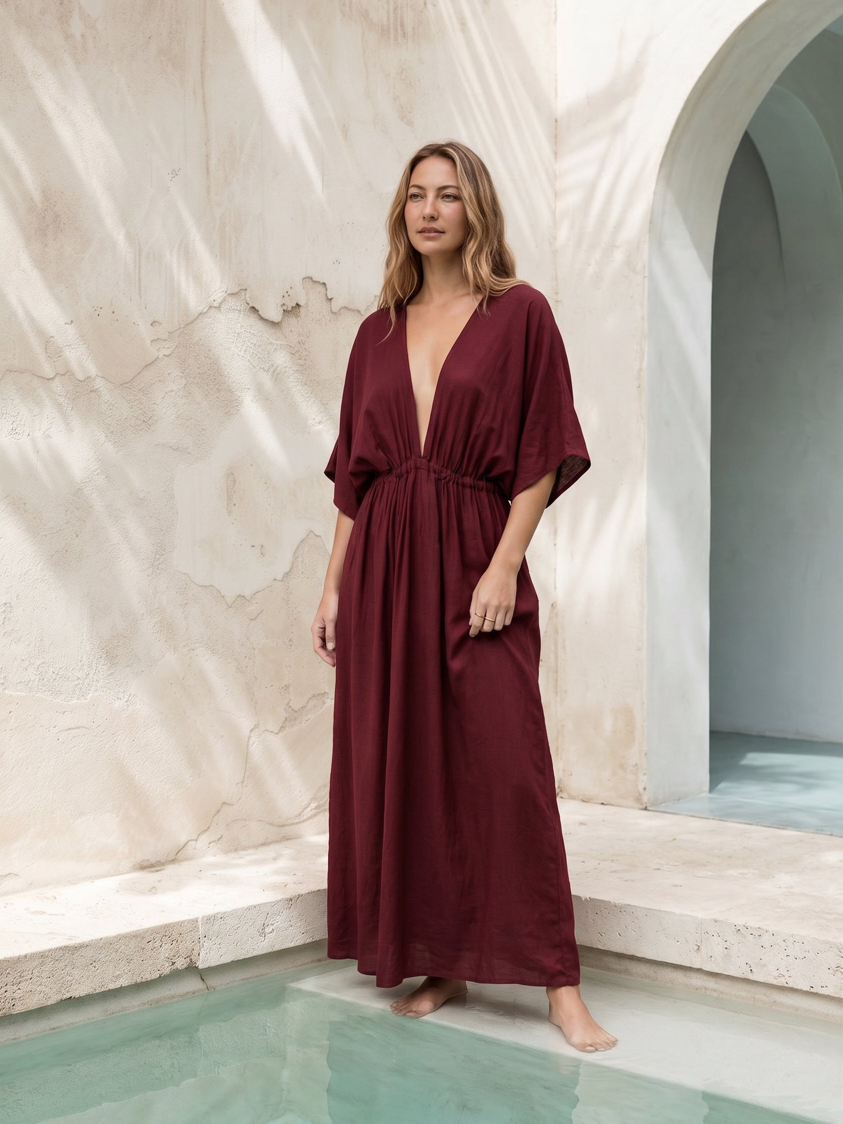 Burgundy Goddess Kaftan Dress worn as an oversized beach cover up, plus size friendly maternity caftan and boho resort maxi dress