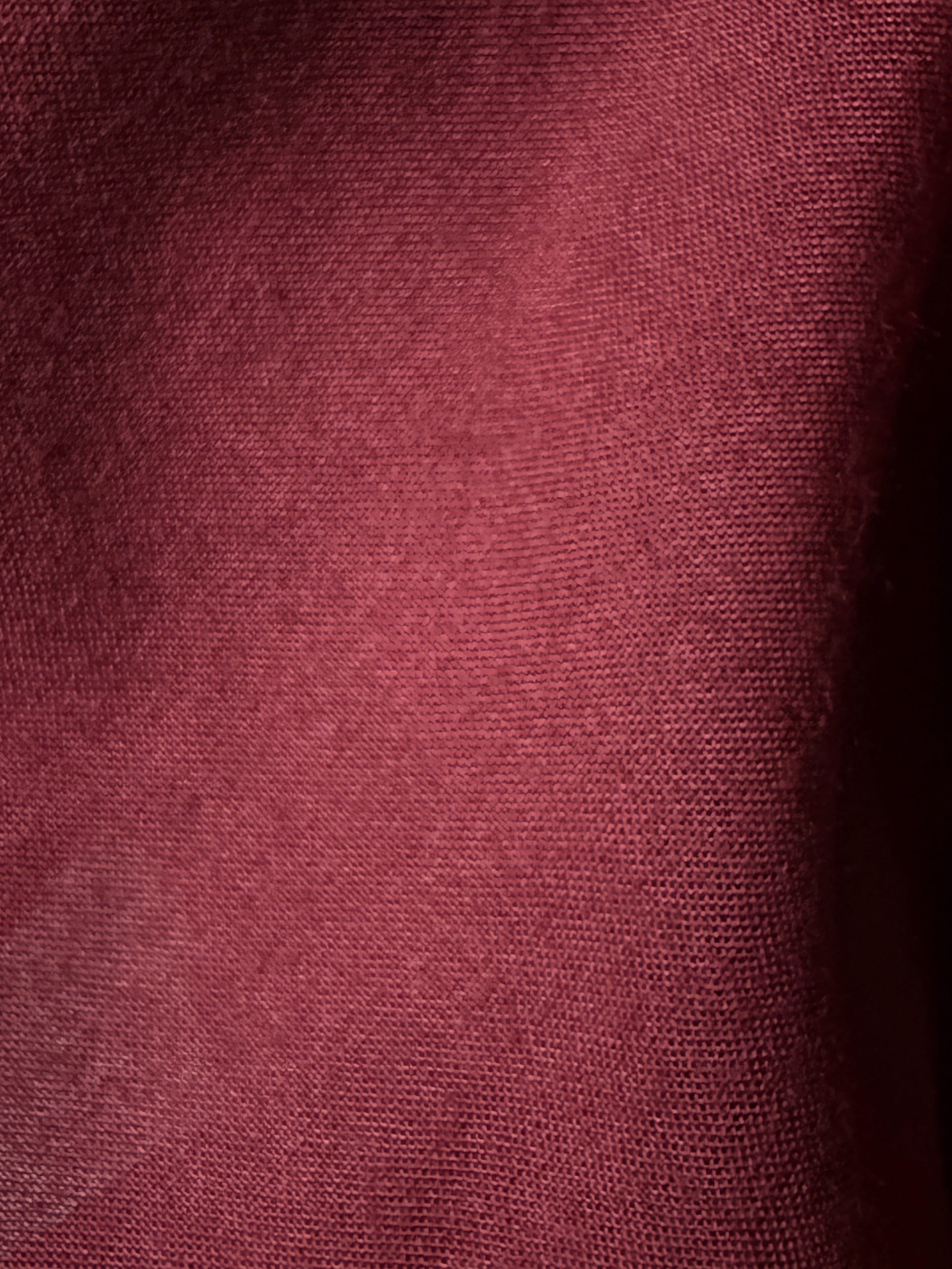 Close-up of a textured maroon fabric surface