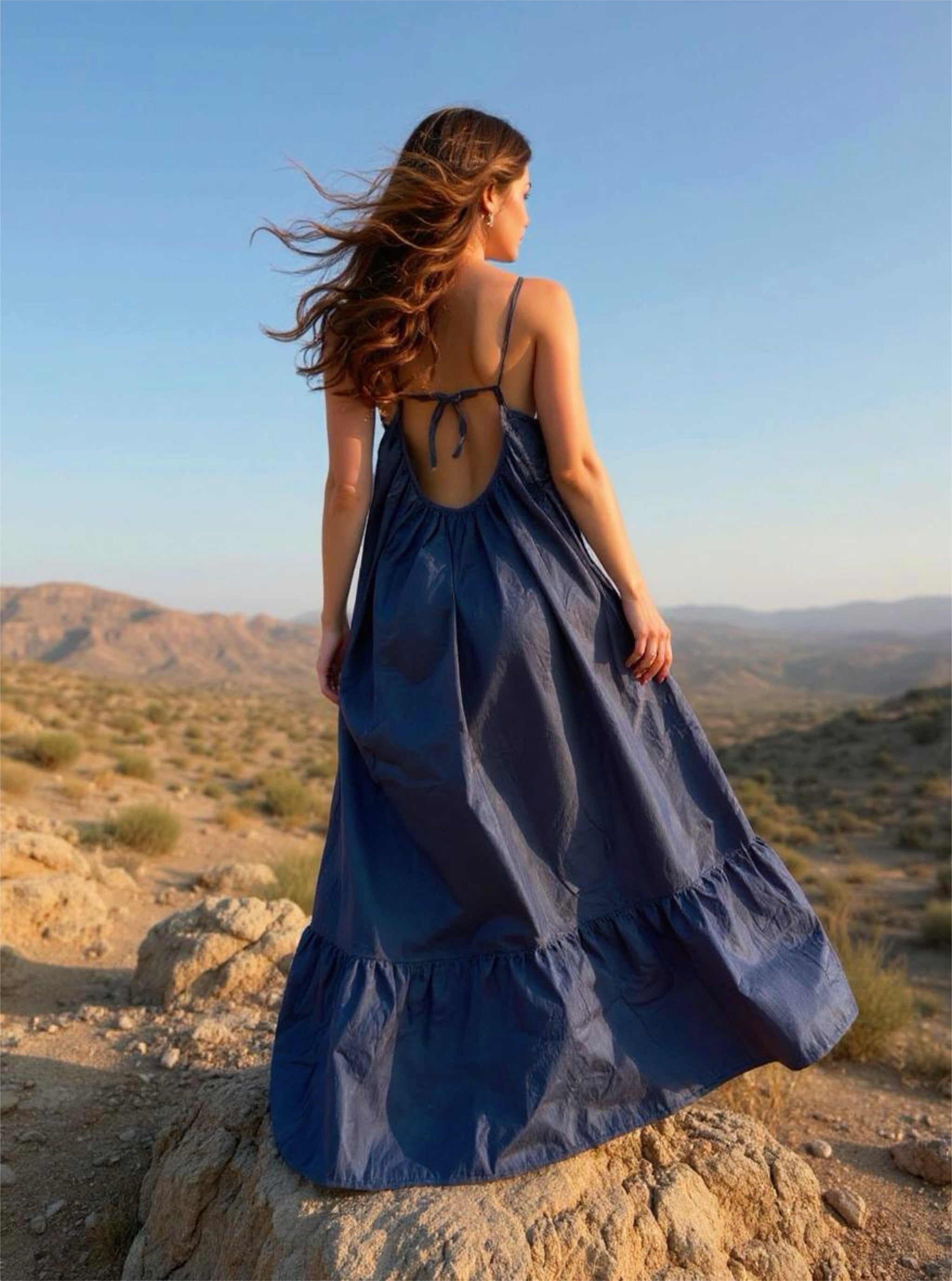 Flowy oversized navy maxi dress with open back and ruffle hem, perfect for beachwear or resort vacations.