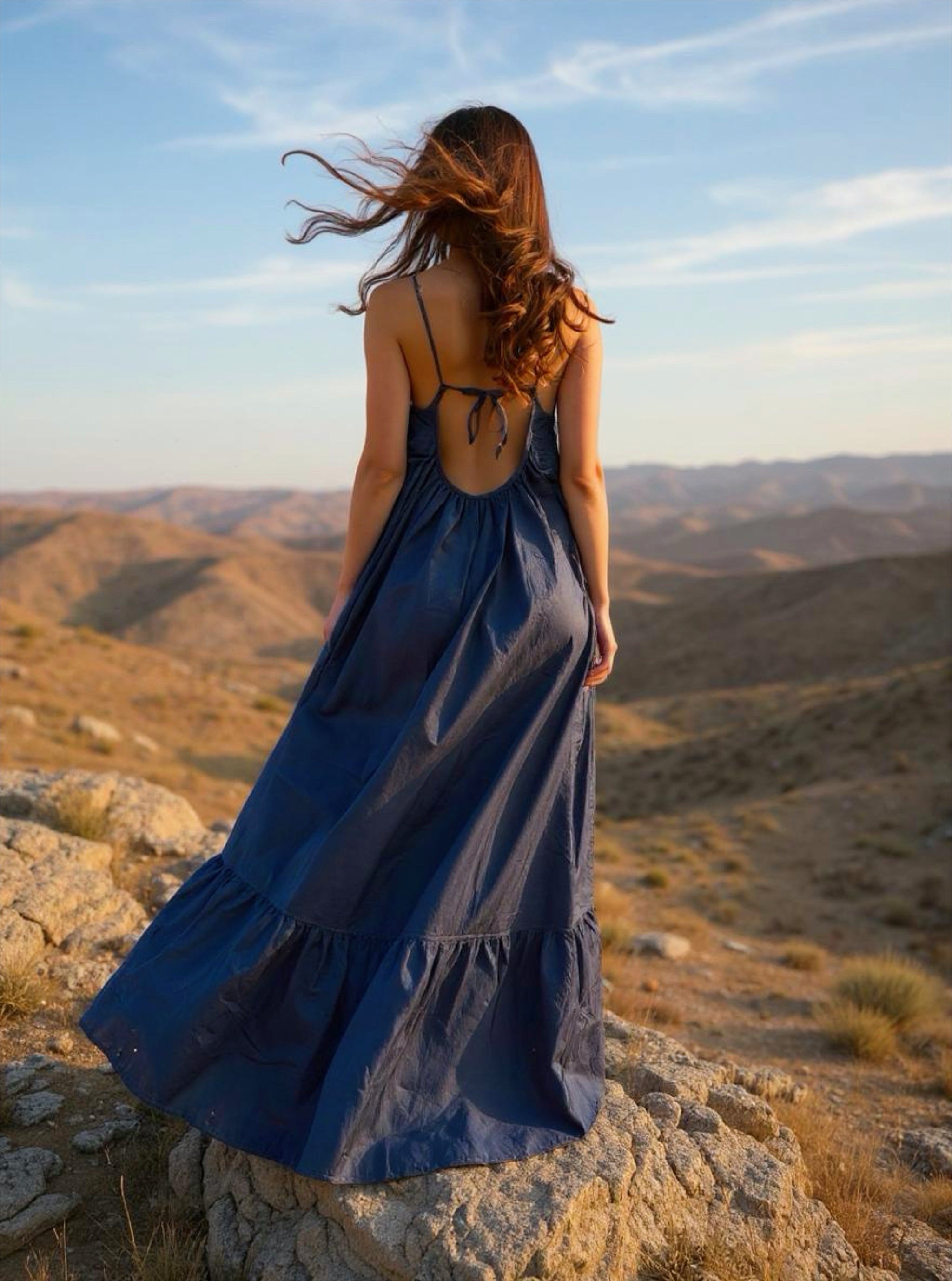 Back view of an oversized navy open-back maxi dress with ruffle hem and pockets, ideal for summer and resort wear.