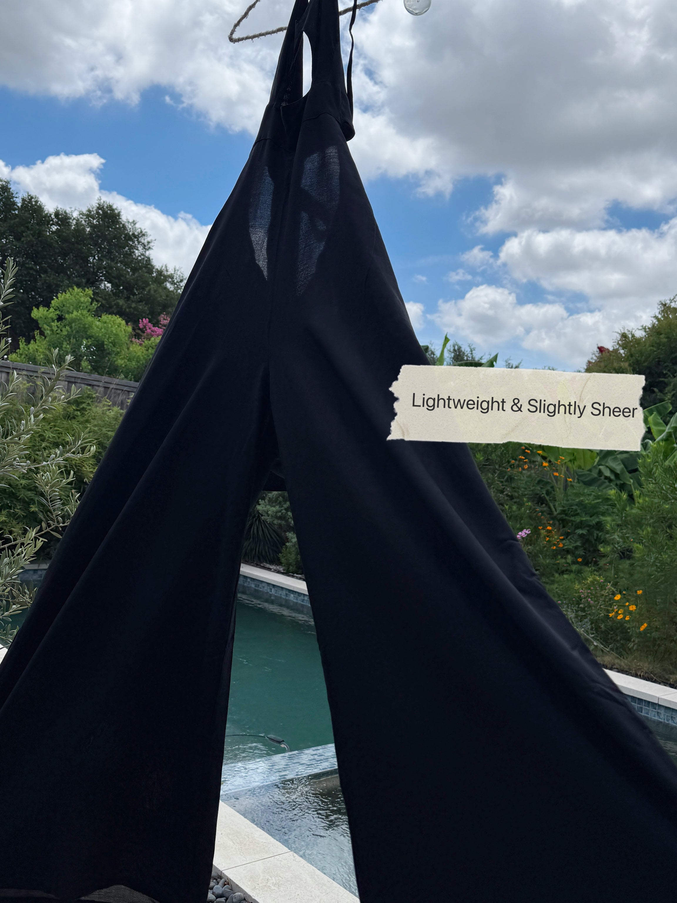 Close-up of waist cut-out detail and elastic band—hand-dyed summer jumpsuit with flowy silhouette.