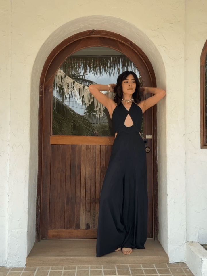 Front view of model in hand-dyed boho cut-out jumpsuit with wide legs and visible pockets—resort summer outfit.