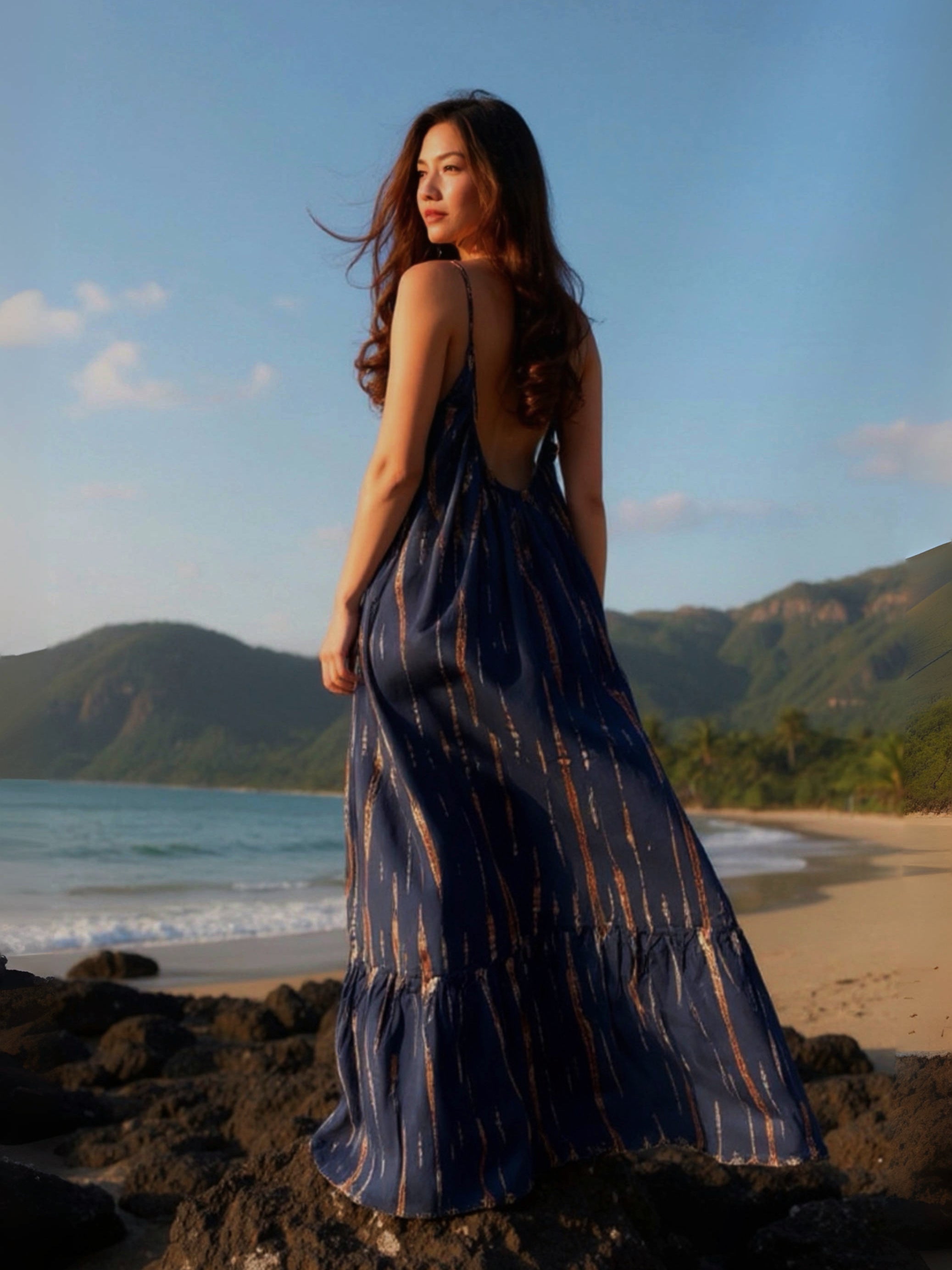 Navy tie-dye Mali backless maxi dress styled with gold accessories, designed for  beach dress, daytime outings or evening parties.
