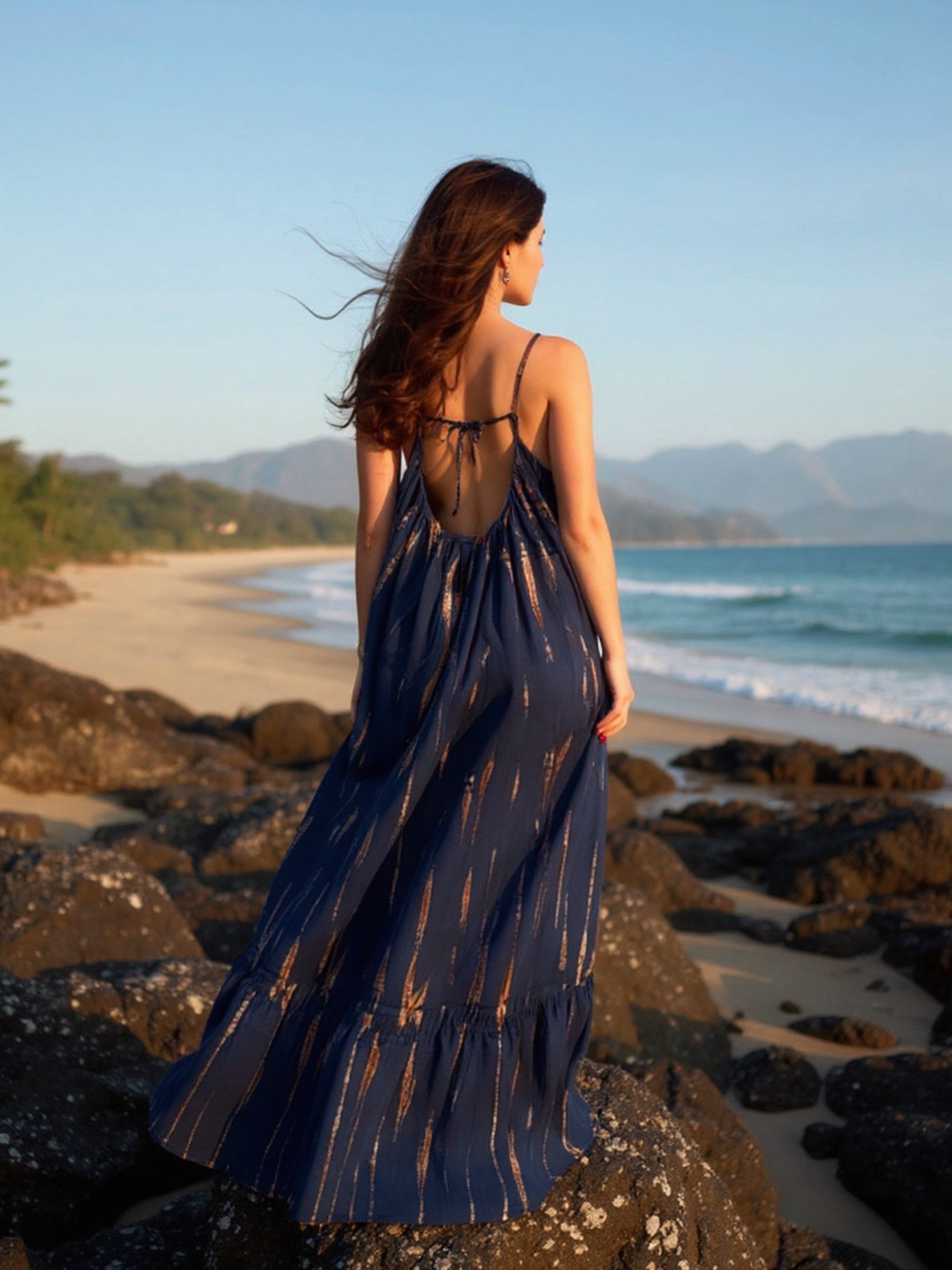 Navy tie-dye Mali backless maxi dress styled with gold accessories, designed for  beach dress, daytime outings or evening parties.
