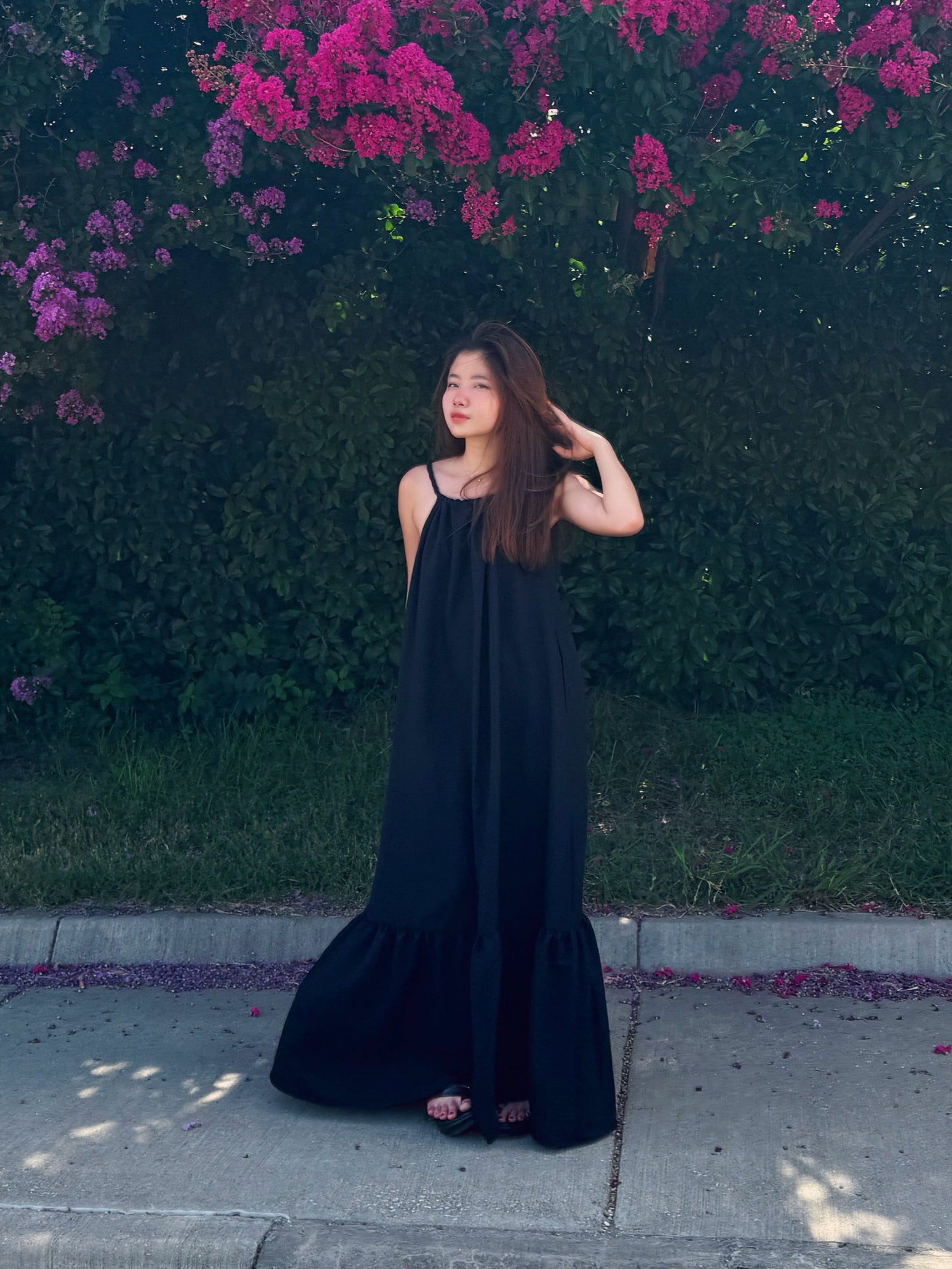 Model wearing Olivia Open Back Maxi Dress with adjustable rope straps and ruffles — perfect vacation outfit.