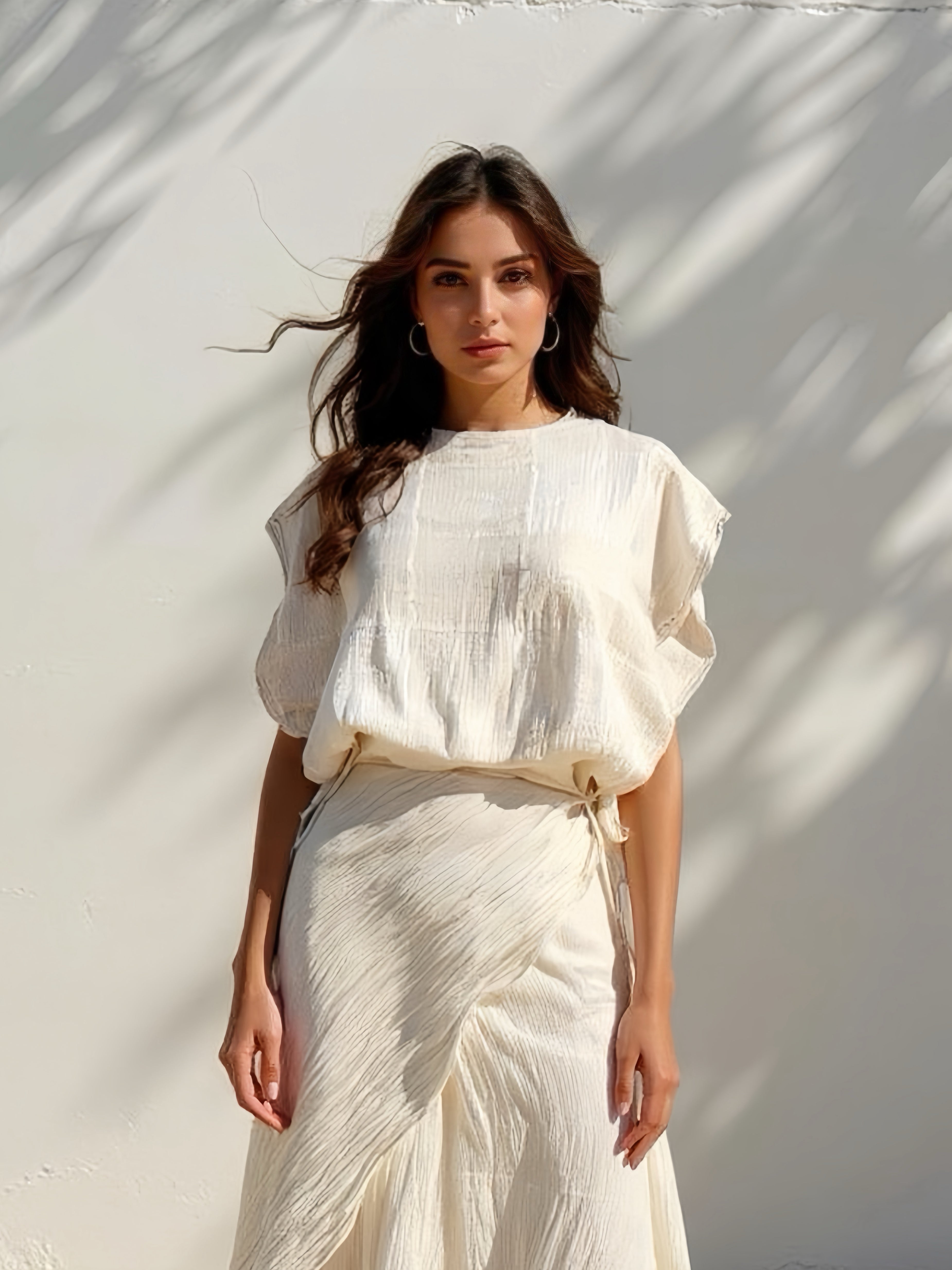 Model wearing off-white crinkle cotton kaftan top with flowing sleeves, handmade