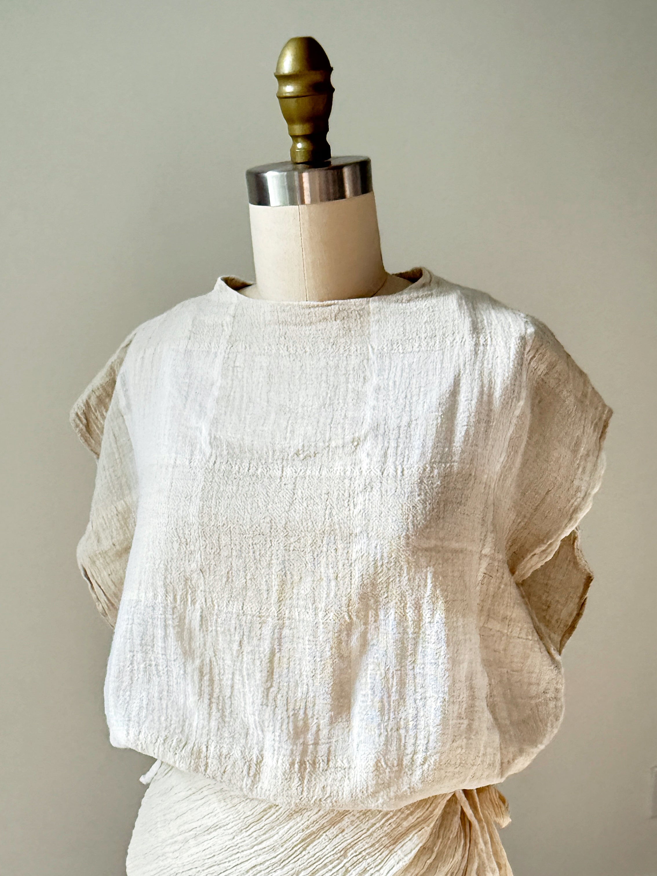 Model wearing off-white crinkle cotton kaftan top with flowing sleeves, handmade
