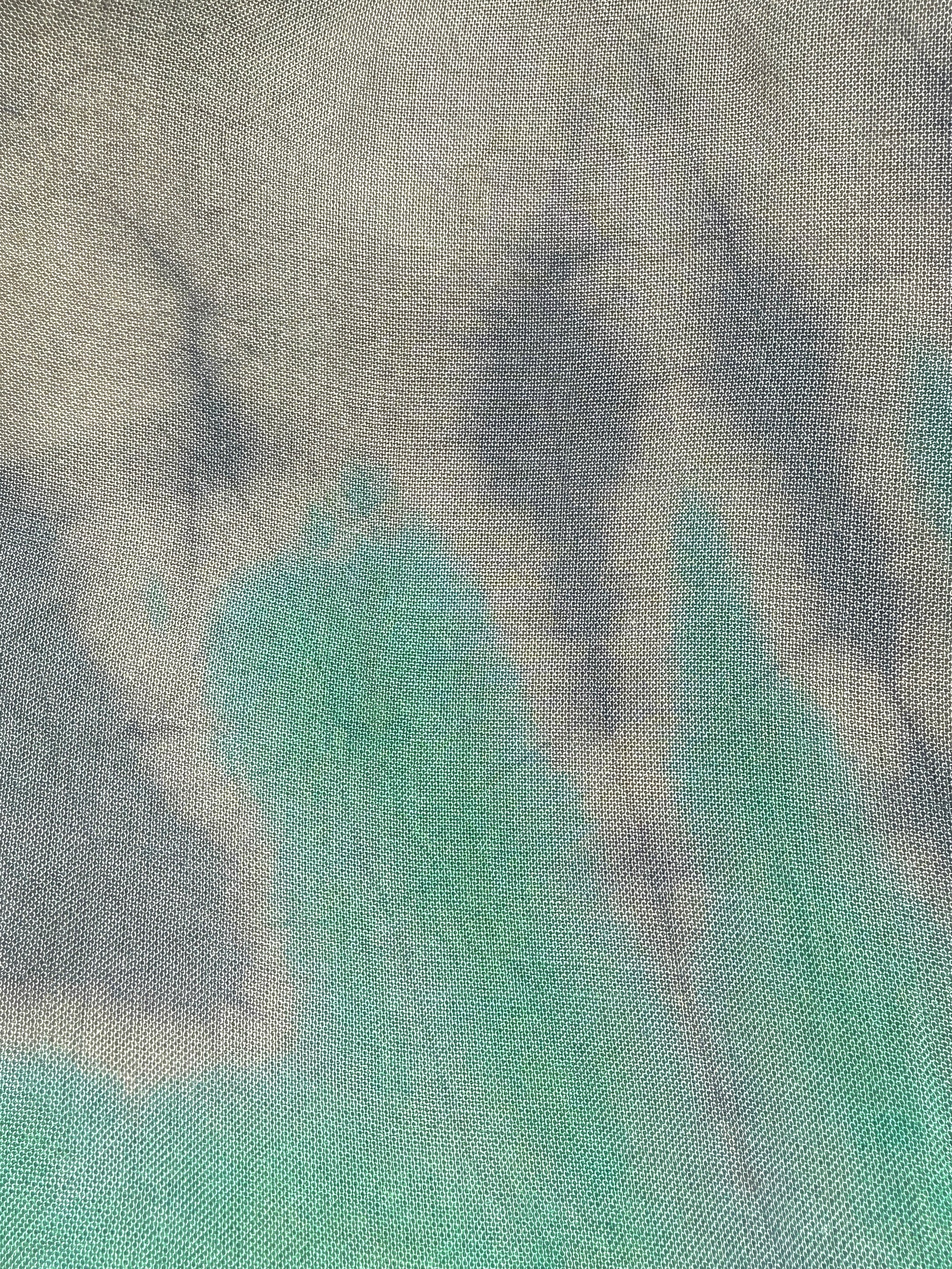 Textured fabric with tie dye green and gray pattern
