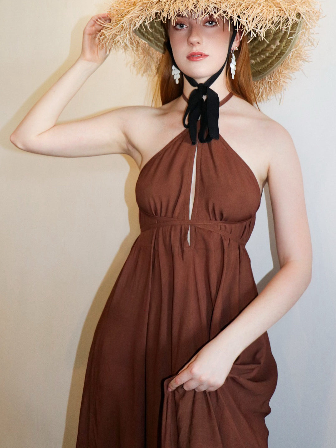 Flowy, hand-dyed toffee brown maxi dress with adjustable halter ties, styled as resort wear with an open back and side slit
