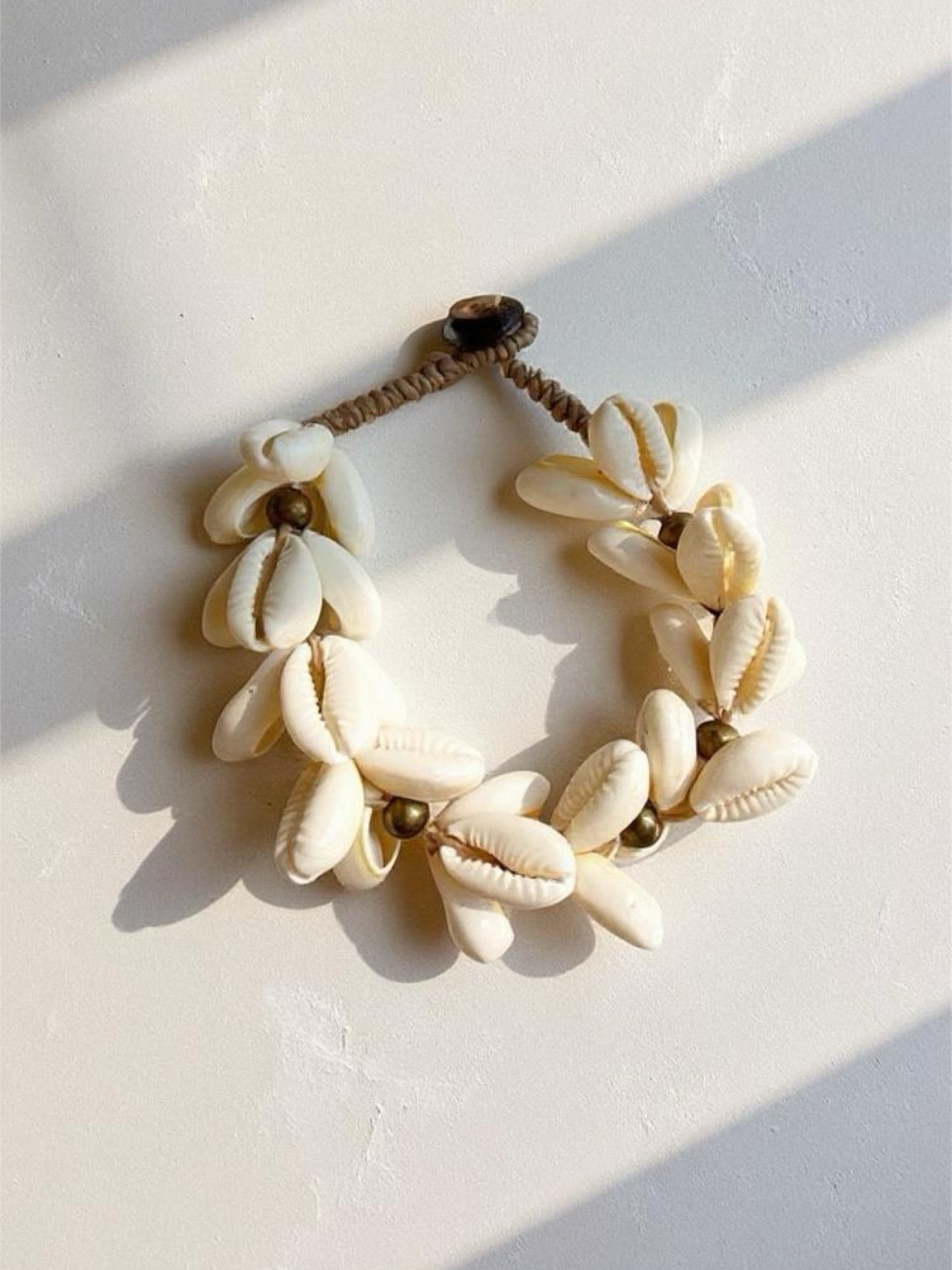 Ocean cowrie seashell bracelet handmade in Thailand, boho beach jewelry for resort wear, summer outfits, and eco-friendly gifts.