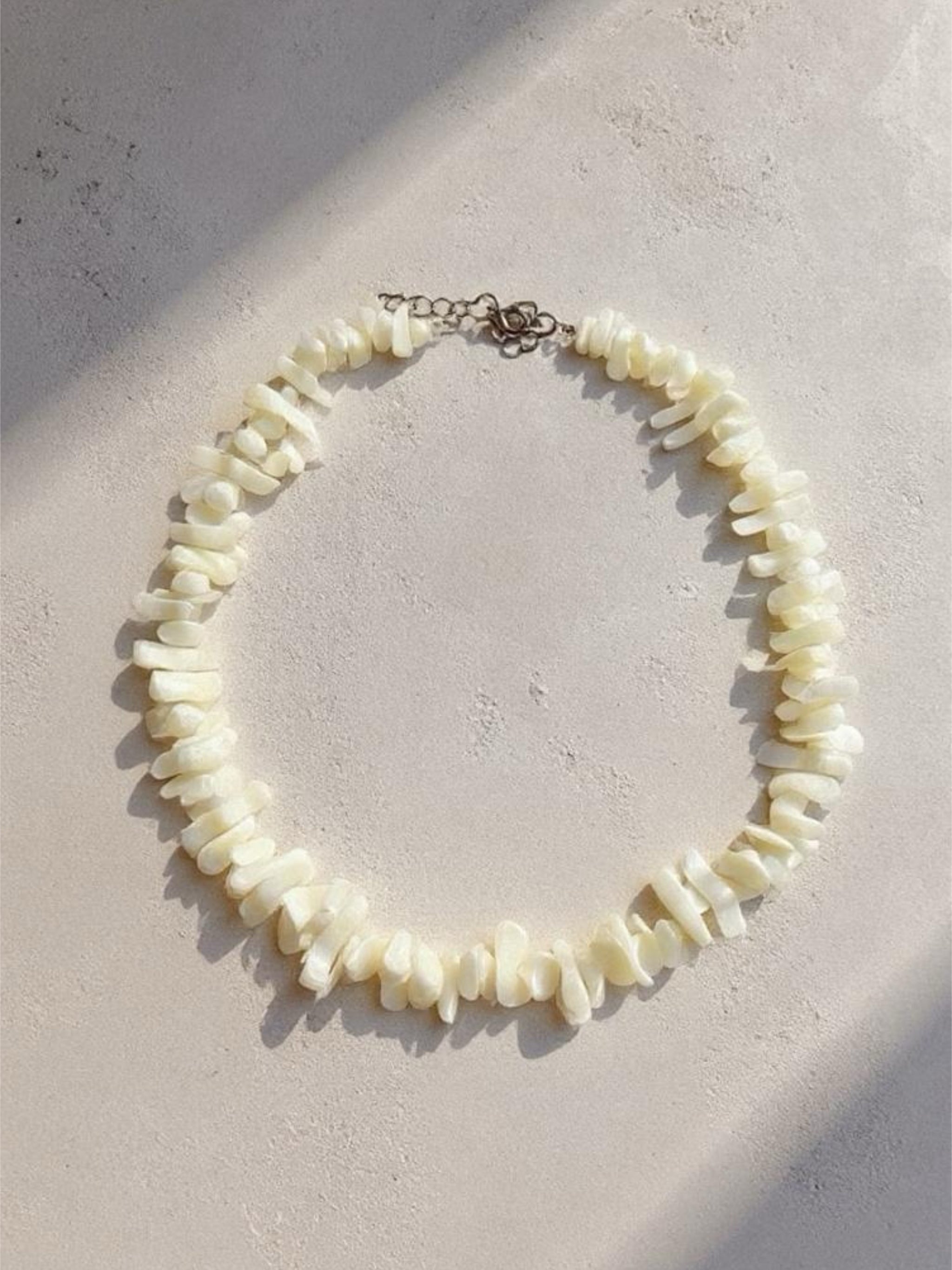 Handmade mother of pearl shell choker necklace with tribal silver clasp, perfect for beach weddings, vacations, and boho outfits.
