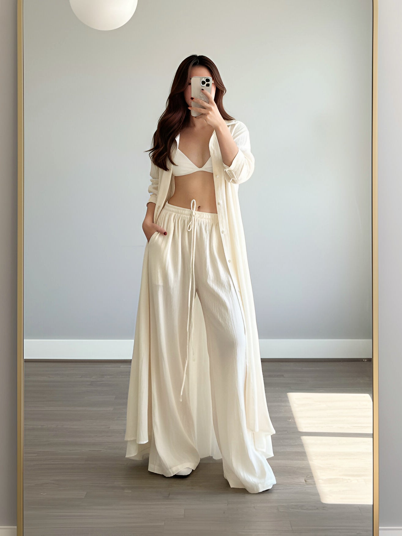 Model wearing organic cotton wide-leg pants with elastic waist, lightweight boho beach pants for summer and resort wear