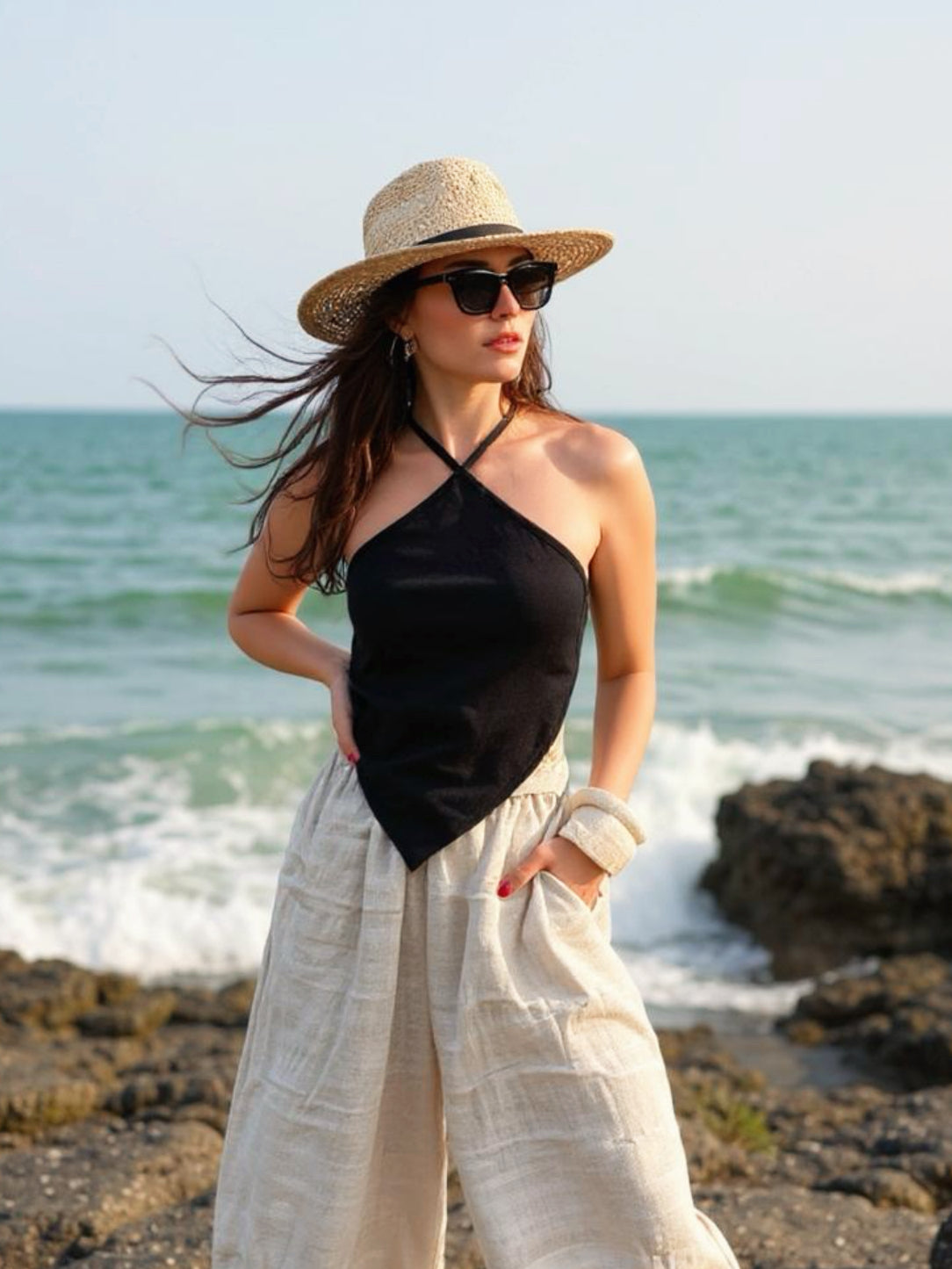 Model wearing natural hemp handkerchief halter crop top – sustainable boho festival and beach vacation outfit.