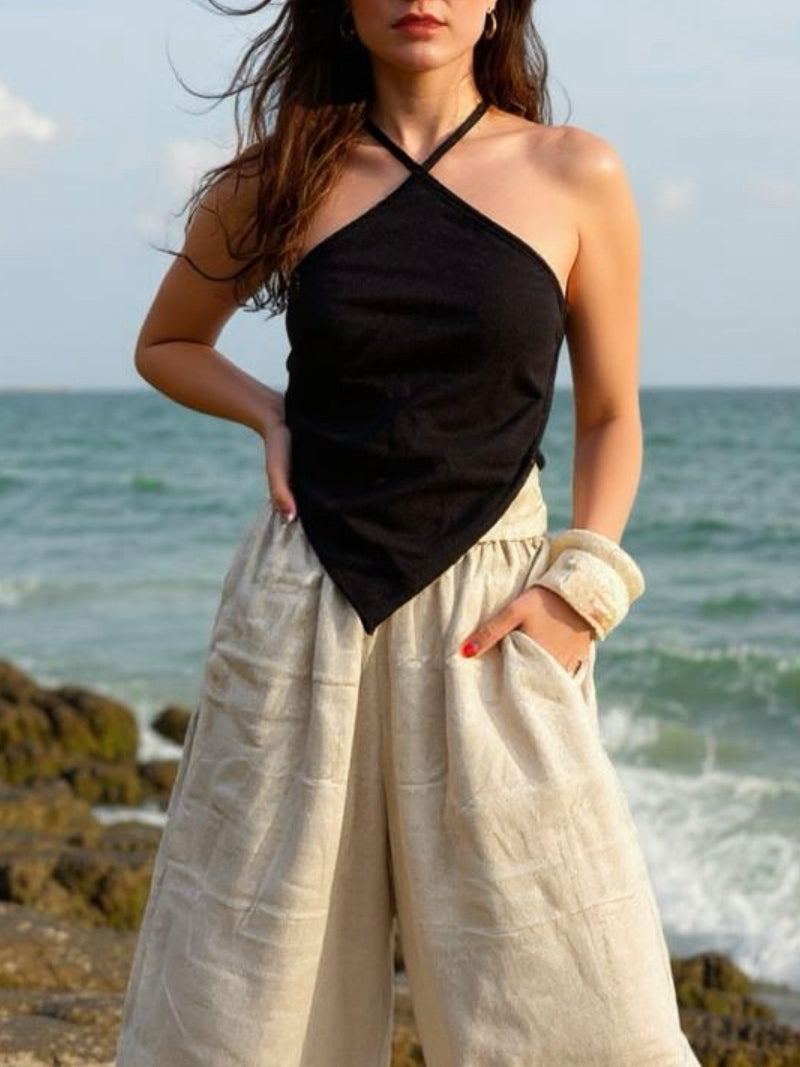 Model wearing natural hemp handkerchief halter crop top – sustainable boho festival and beach vacation outfit.