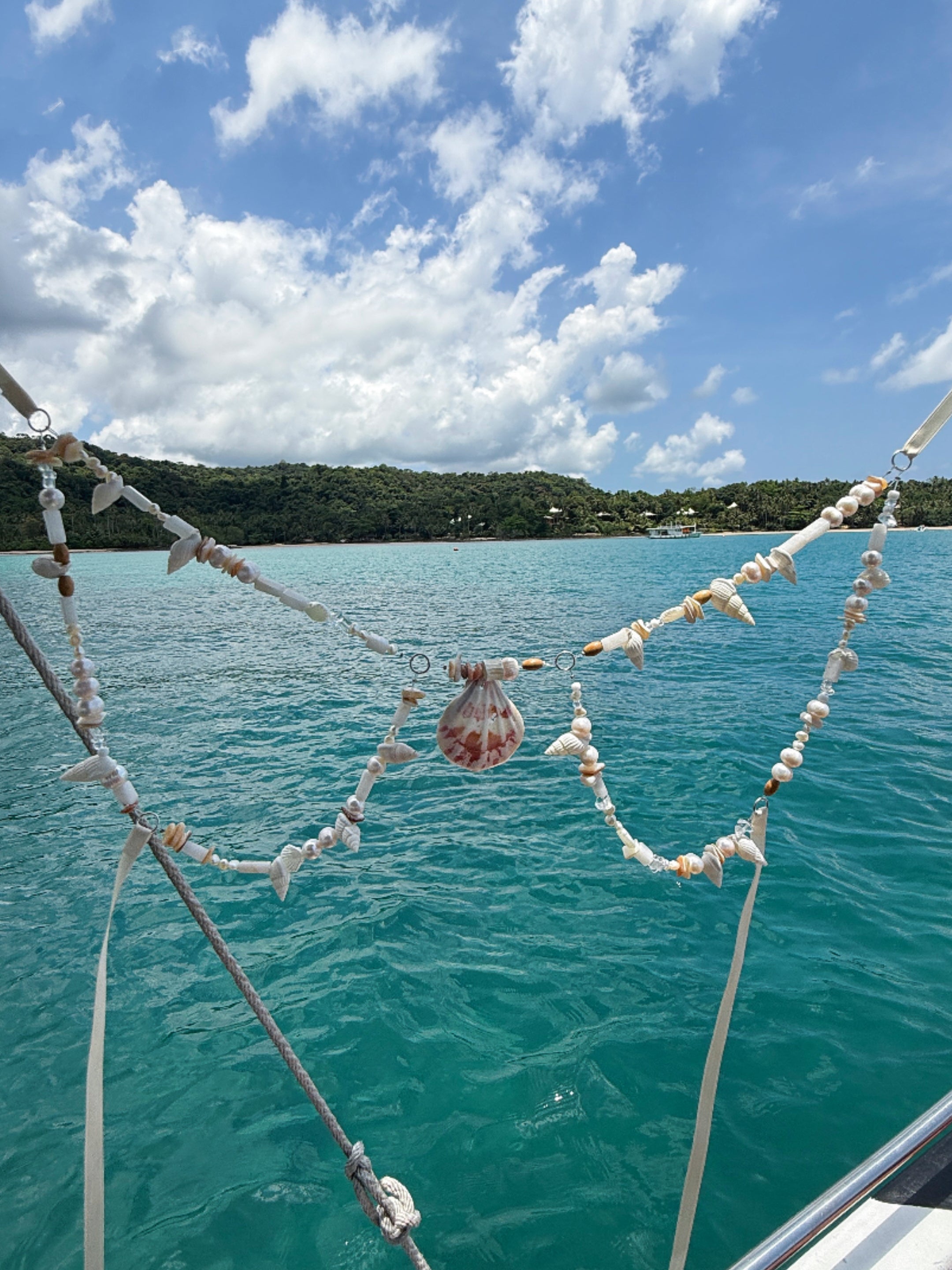 Handcrafted Boho Mermaid Pearl Bra made with real shells and pearl details, styled as a festival top or summer beachwear accessory—paired with a boho choker necklace by Coco de Chom.