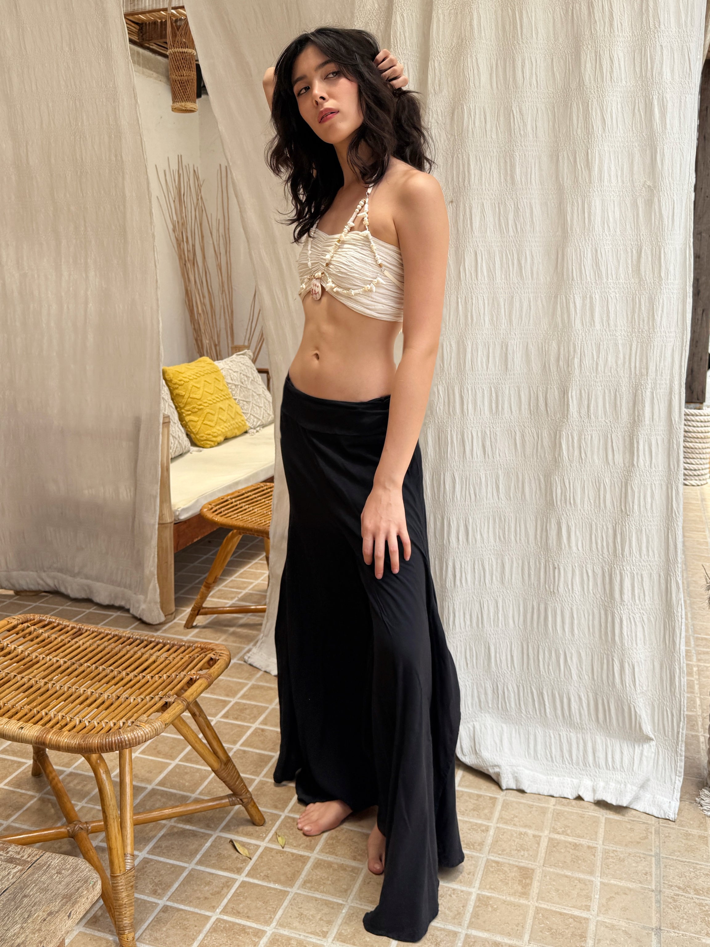 Model wearing black boho wide leg pants with knee-high side slits, relaxed elastic waistband, and flowy rayon fabric—perfect for yoga, beach, and casual wear.