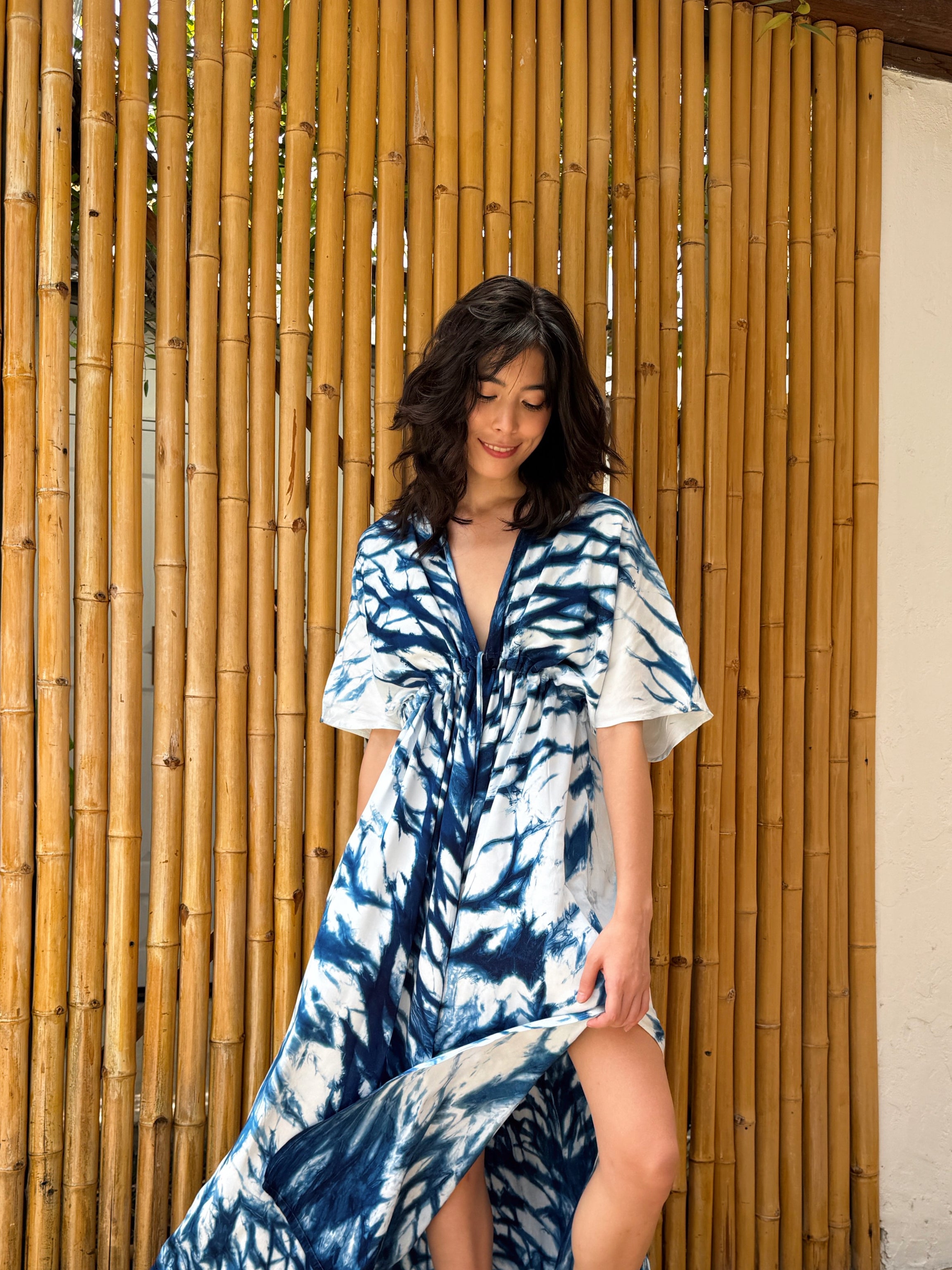 Model wearing the Limited Edition Kori Natural Indigo Goddess Maxi Dress, handcrafted with traditional tie-dye techniques using natural indigo—features a deep V-neckline, flowy silhouette, and adjustable waist, showcasing artisan-made, eco-friendly fashion.