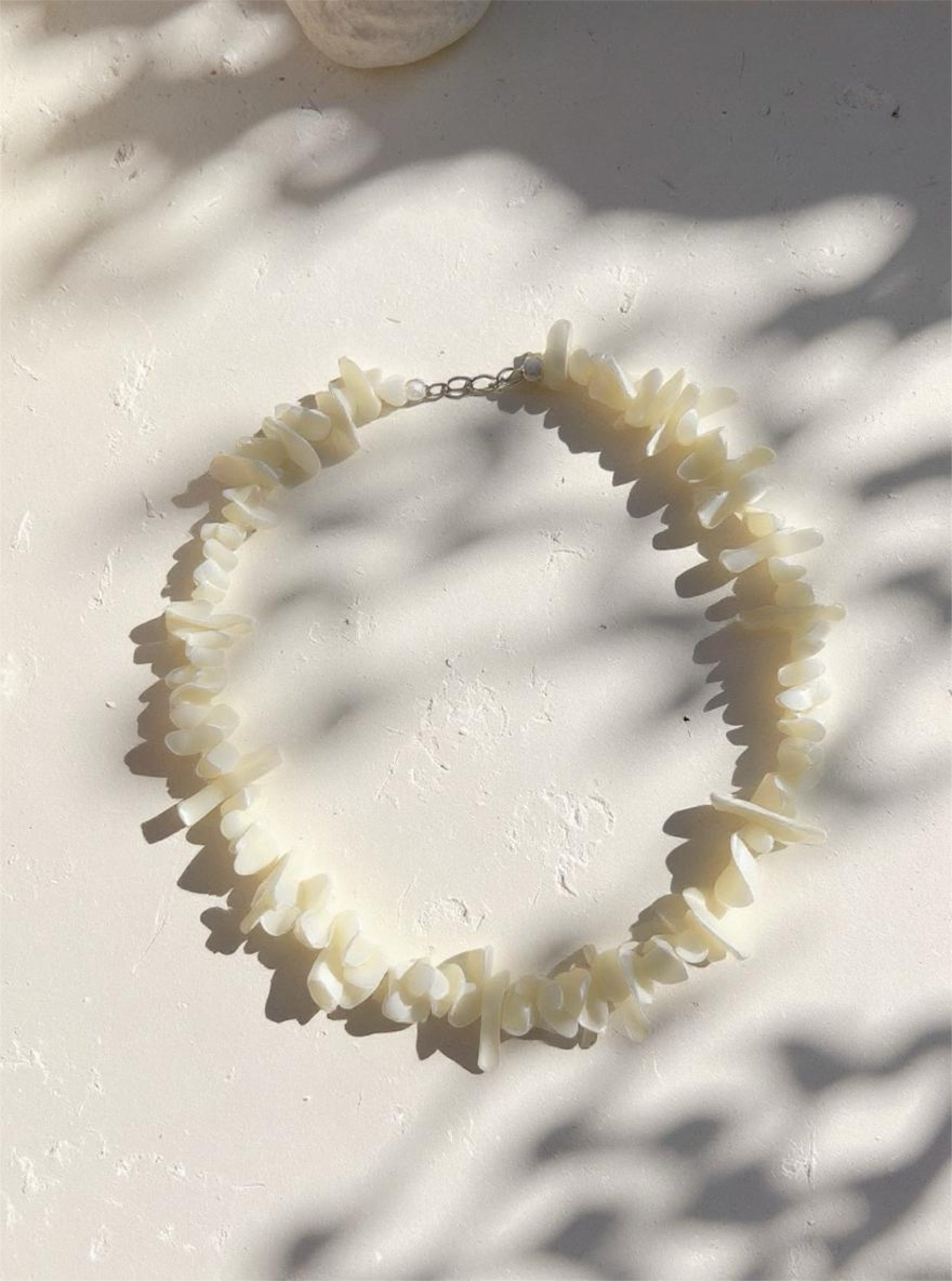 Handmade mother of pearl shell choker necklace with tribal silver clasp, perfect for beach weddings, vacations, and boho outfits.