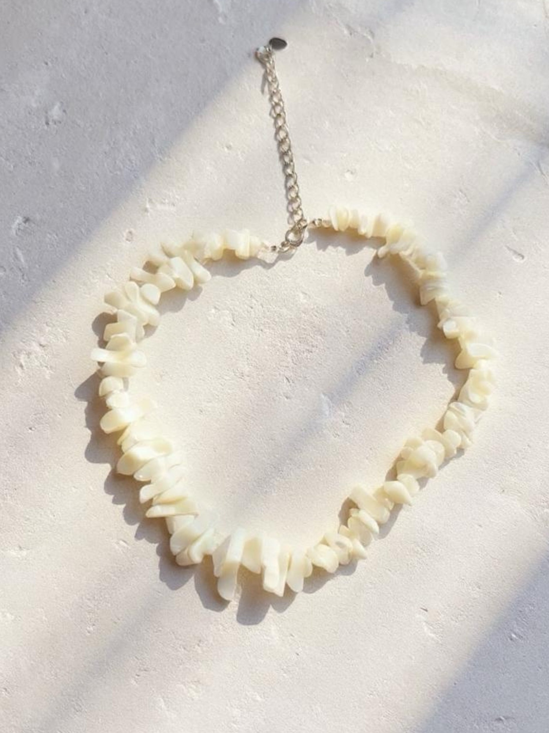 Handmade mother of pearl shell choker necklace with tribal silver clasp, perfect for beach weddings, vacations, and boho outfits.