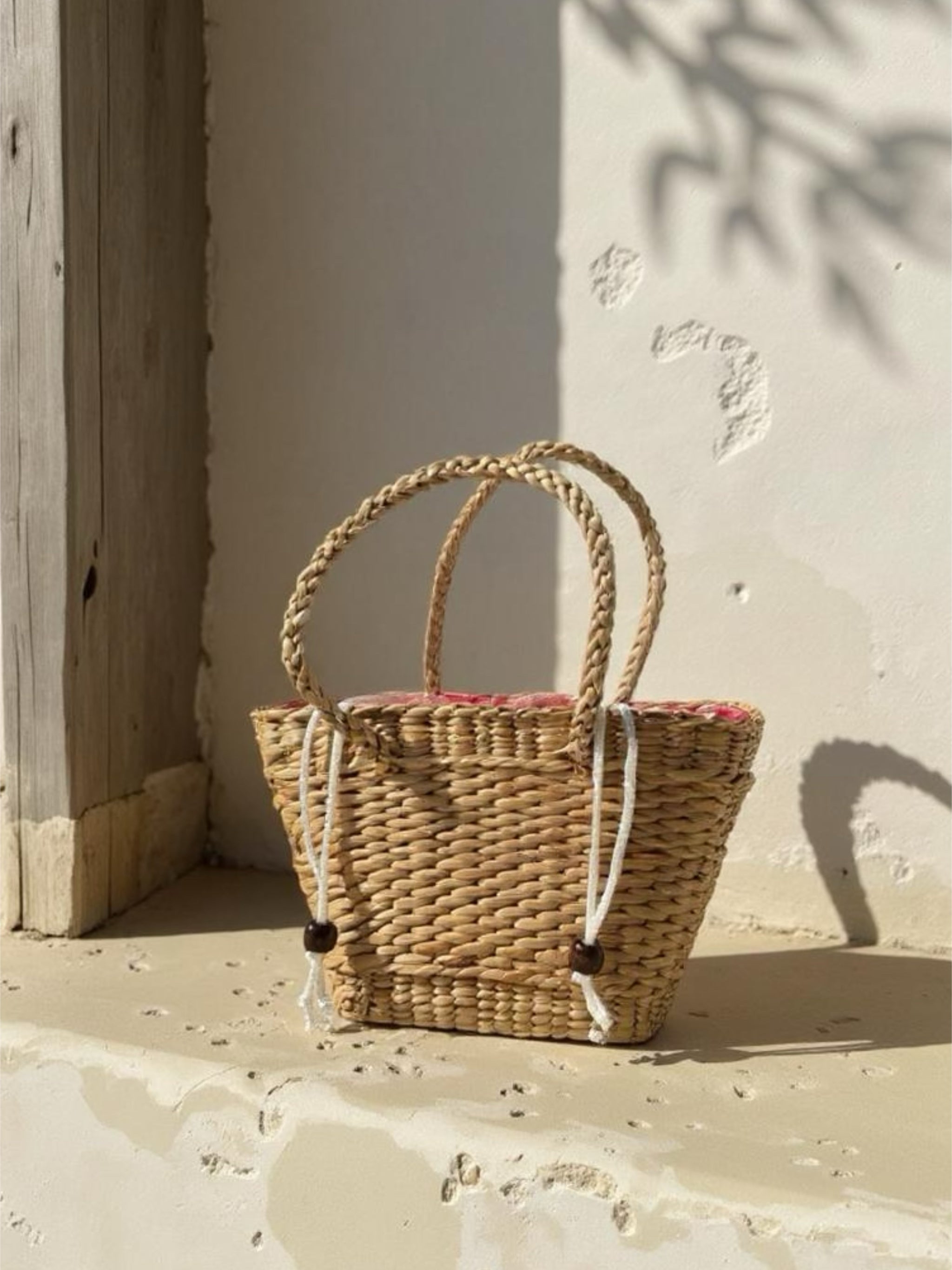 Handwoven straw mini tote bag with red gingham lining