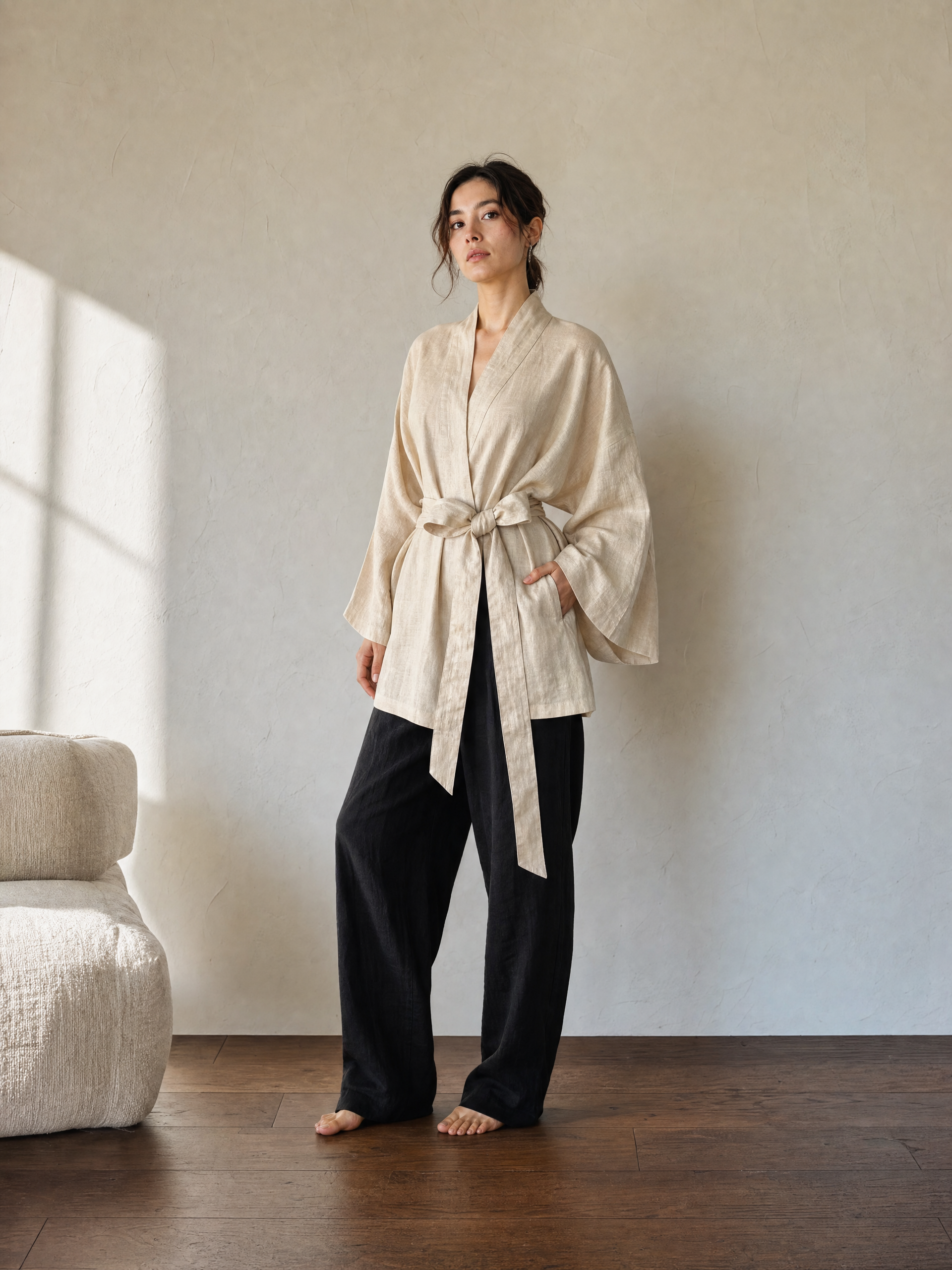 Natural cream linen kimono jacket with oversized wrap fit, wide sleeves, pockets, and removable waist tie, styled as a resort robe and everyday linen layer